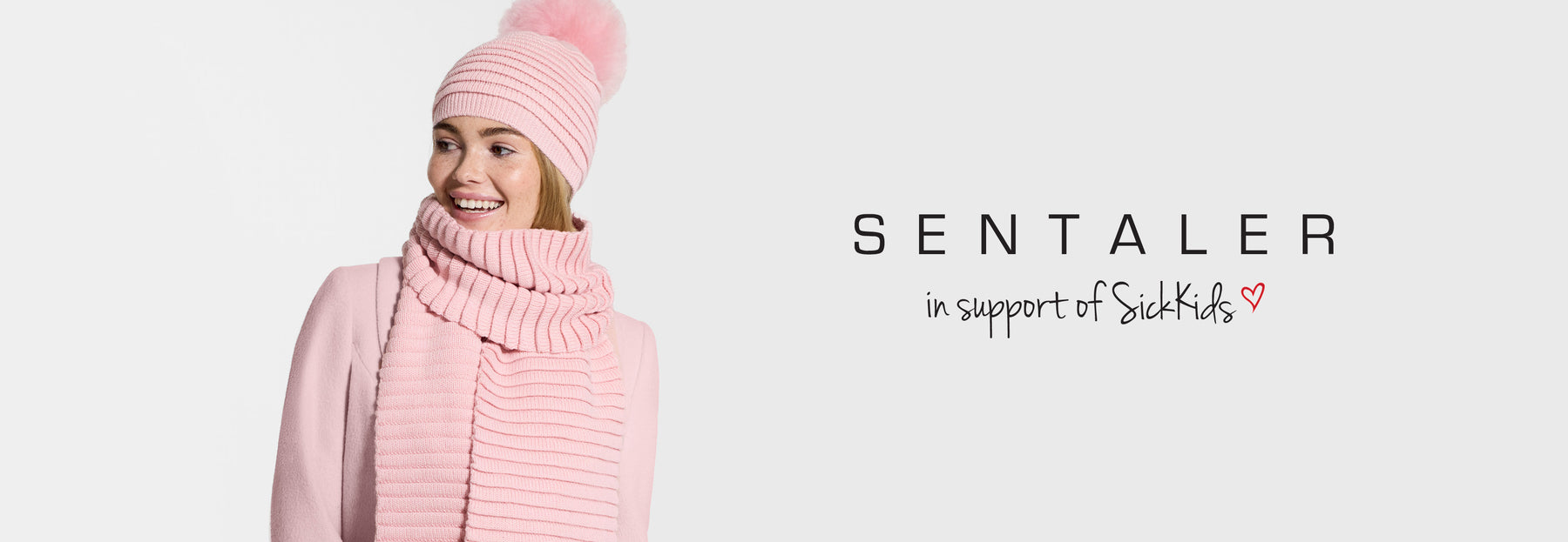 Sentaler Adult Ribbed Hat With Oversized Fur Pompon and Ribbed Scarf featured in Baby Alpaca and available in Pink. Seen from front on model.