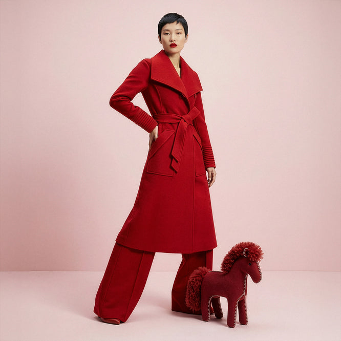 Front view of model wearing a Sentaler scarlet red long wrap coat made of baby alpaca wool, with a wide collar, worn belted.