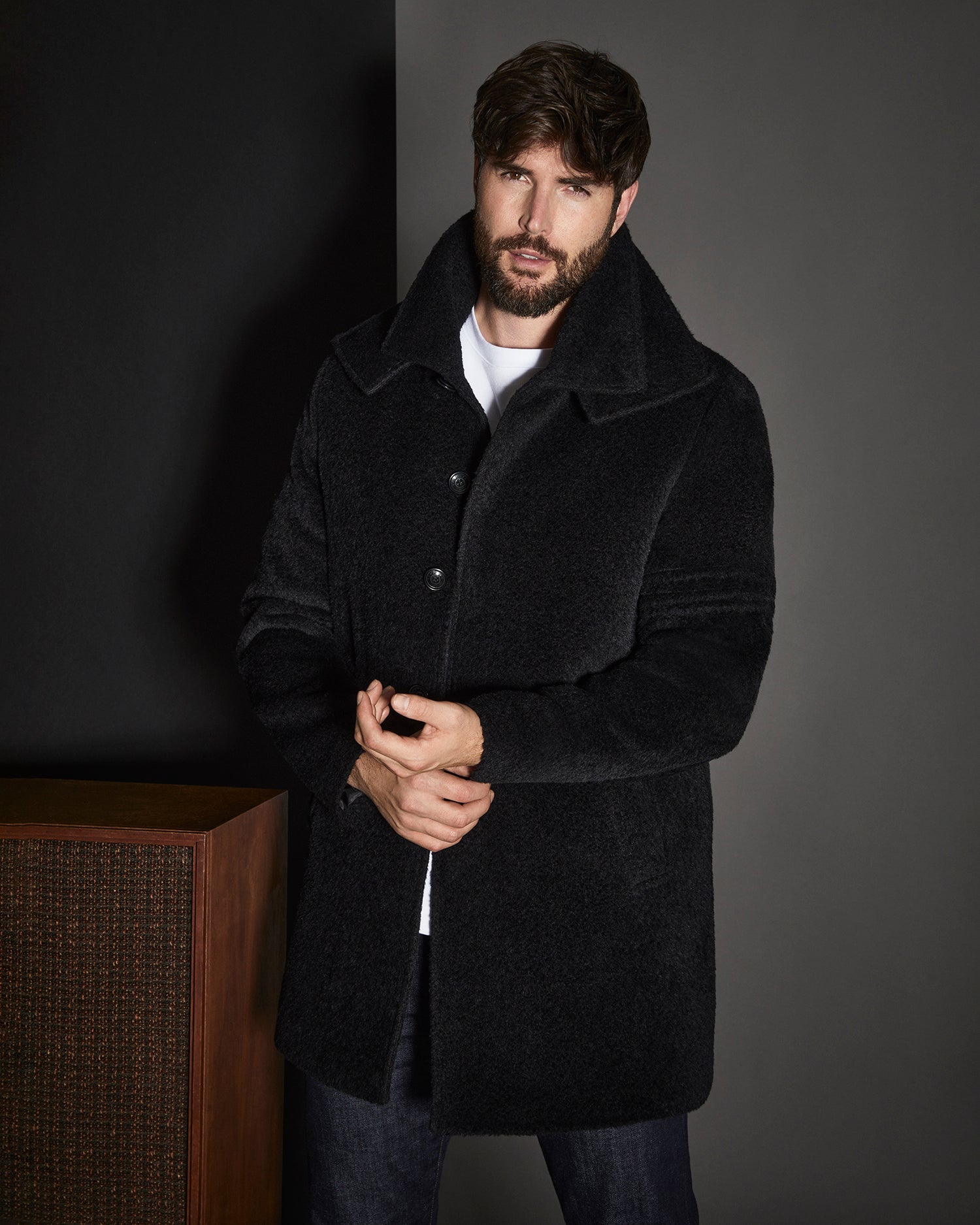 Man wearing Sentaler men bouclé alpaca double collar topcoat in black.