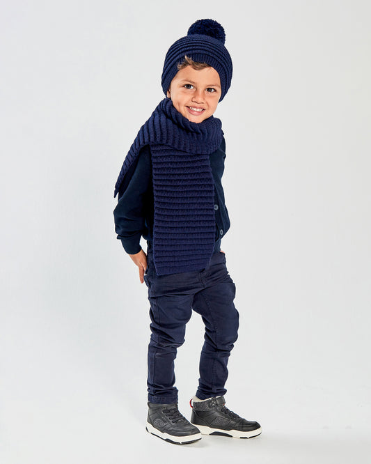 Sentaler Kids Ribbed Navy Scarf & Pompon Hat (1-5 Years) in Baby Alpaca yarn. Seen from side on boy model.