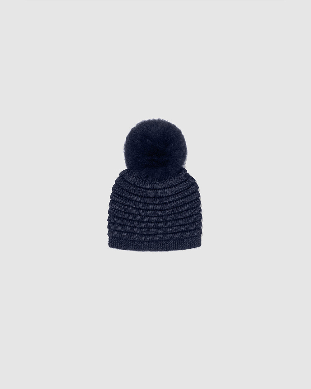 Sentaler Kids Ribbed Navy Hat with Fur Pompon (4-5 Years) in Baby Alpaca yarn. Seen as off figure.