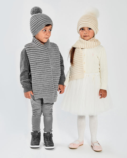 Sentaler Kids Ribbed Grey Hat with Knit Pompon (1-5 Years) and Kids Ribbed Grey Scarf (1-5 Years) in Baby Alpaca yarn. Seen from front on boy model.