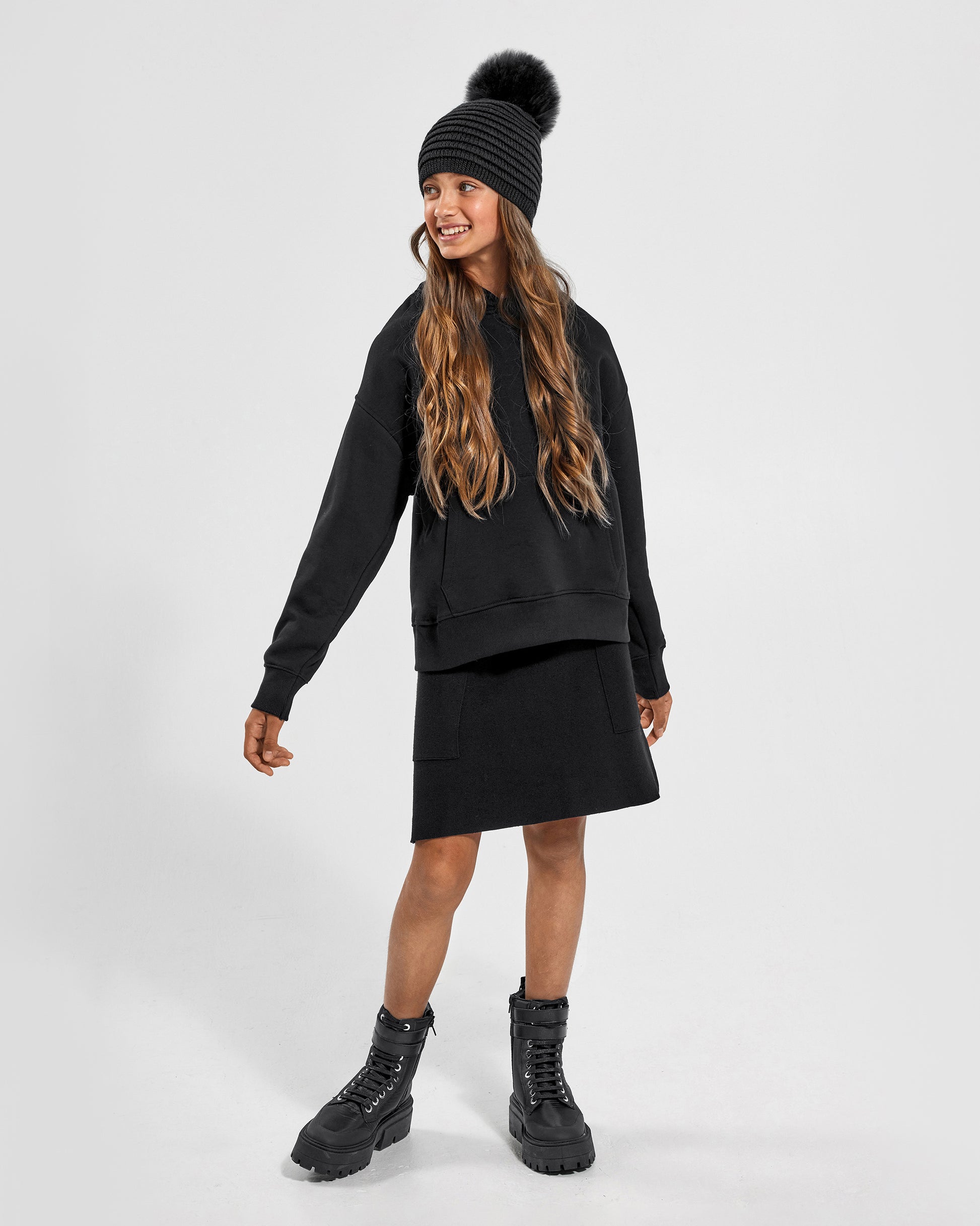 Sentaler Kids Ribbed Grey Hat with Fur Pompon (6-14 Years) in Baby Alpaca yarn. Seen from front on girl model.