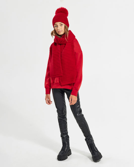 Sentaler Kids Ribbed Red Hat with Fur Pompon (6-14 Years) in Baby Alpaca yarn. Seen from front on girl model.