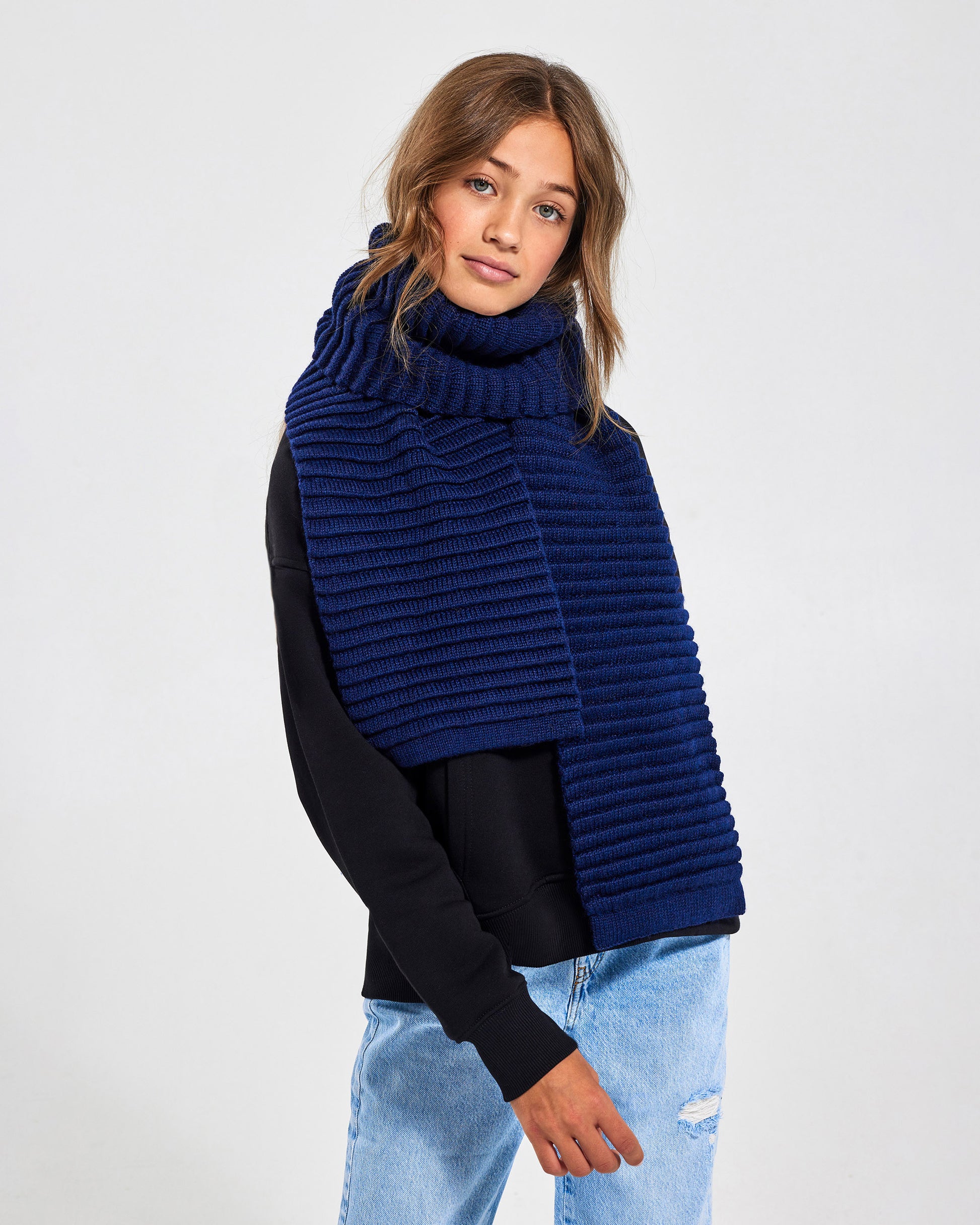 Sentaler Kids Ribbed Navy Scarf (6-14 Years) in Baby Alpaca yarn. Seen from front on girl model.