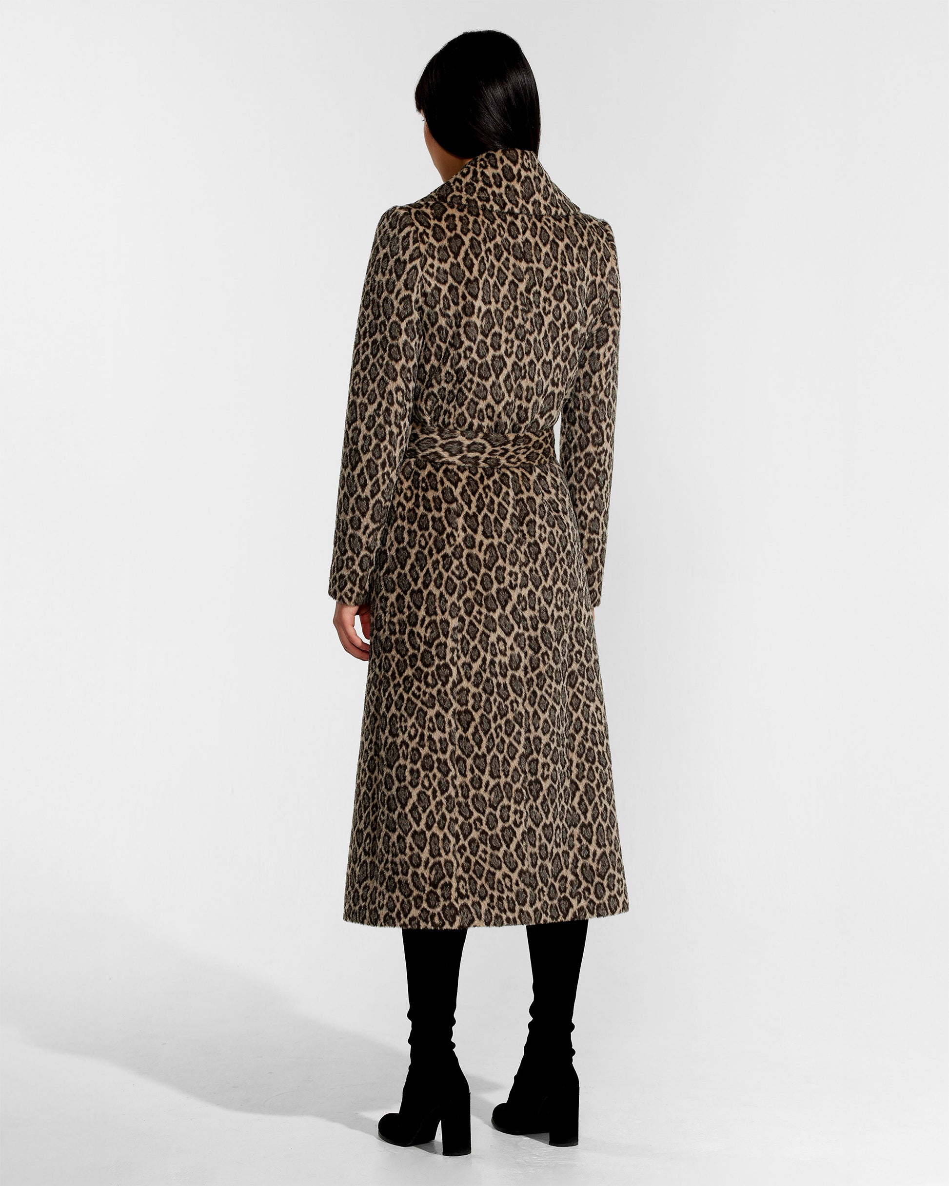 Back view of model wearing a Sentaler leopard wrap coat made of bouclé alpaca wool, with a notched collar, worn belted.