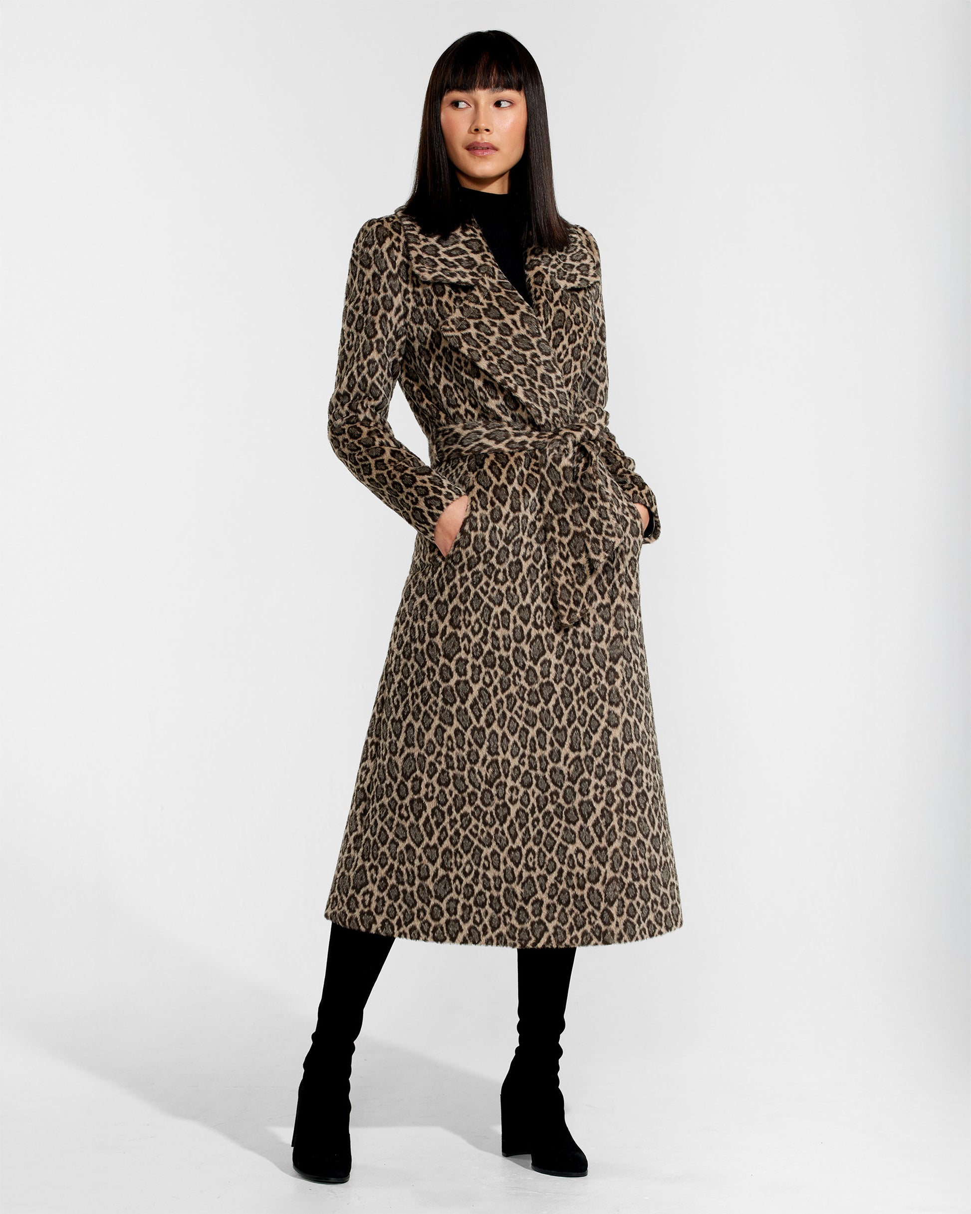 Front view of model wearing a Sentaler leopard wrap coat made of bouclé alpaca wool, with a notched collar, worn belted.