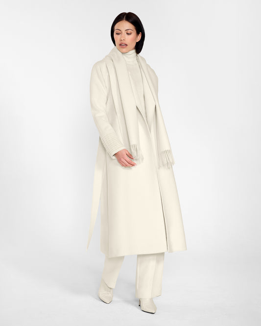 Side view of model wearing Sentaler's adult Ivory classic scarf, made of baby alpaca yarn. 