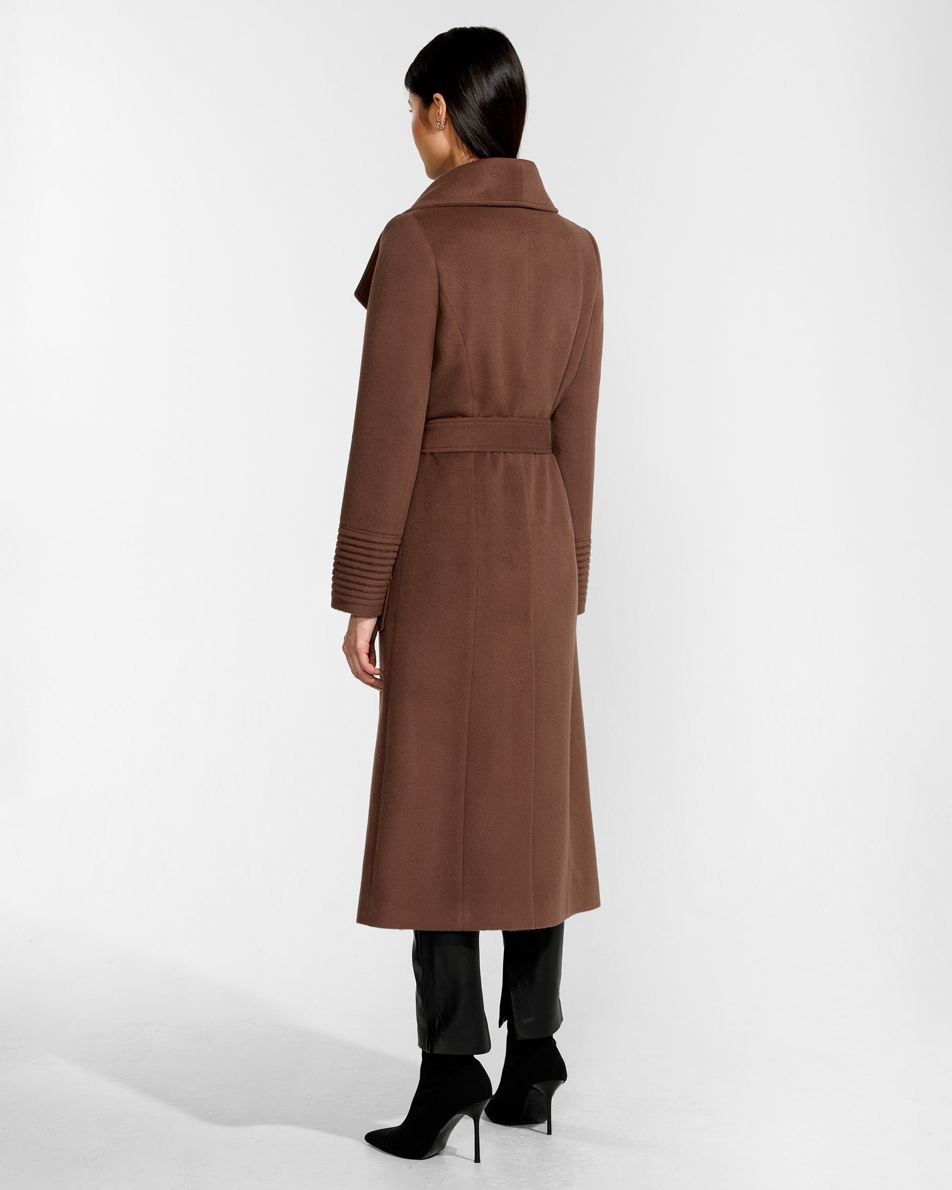 Back view of model wearing a Sentaler sepia brown long wrap coat made of baby alpaca wool, with a wide collar, worn belted.
