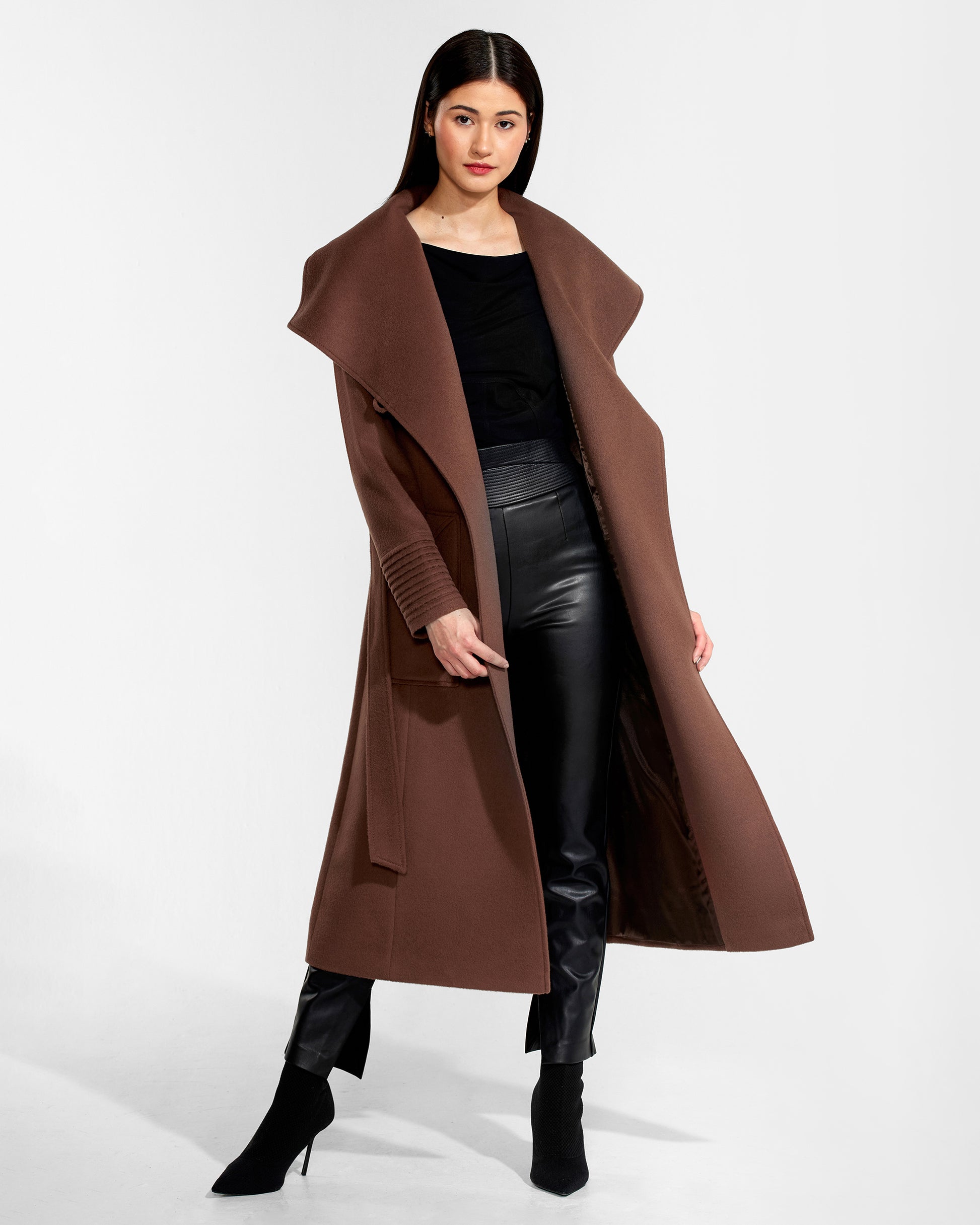 Front view of model wearing a Sentaler sepia brown long wrap coat made of baby alpaca wool, with a wide collar, worn open.