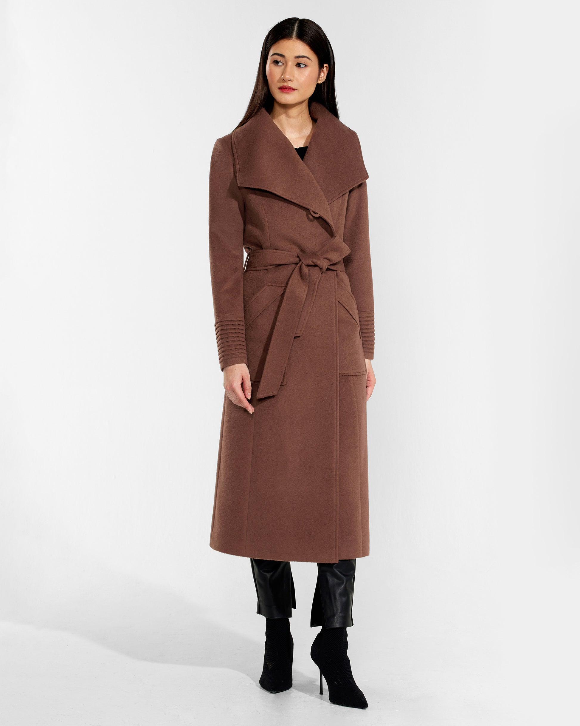 Front view of model wearing a Sentaler sepia brown long wrap coat made of baby alpaca wool, with a wide collar, worn belted.