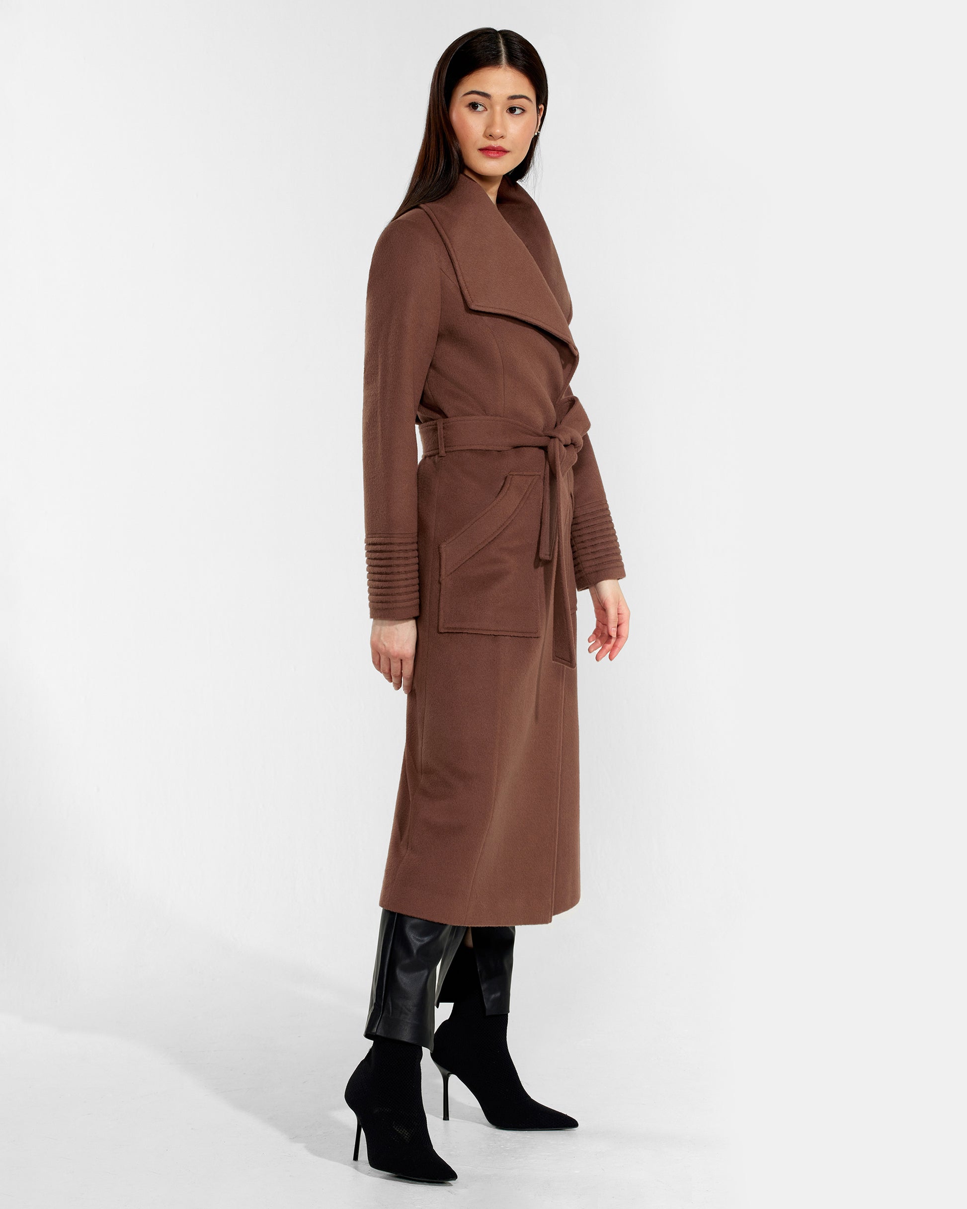 Side view of model wearing a Sentaler sepia brown long wrap coat made of baby alpaca wool, with a wide collar, worn belted.