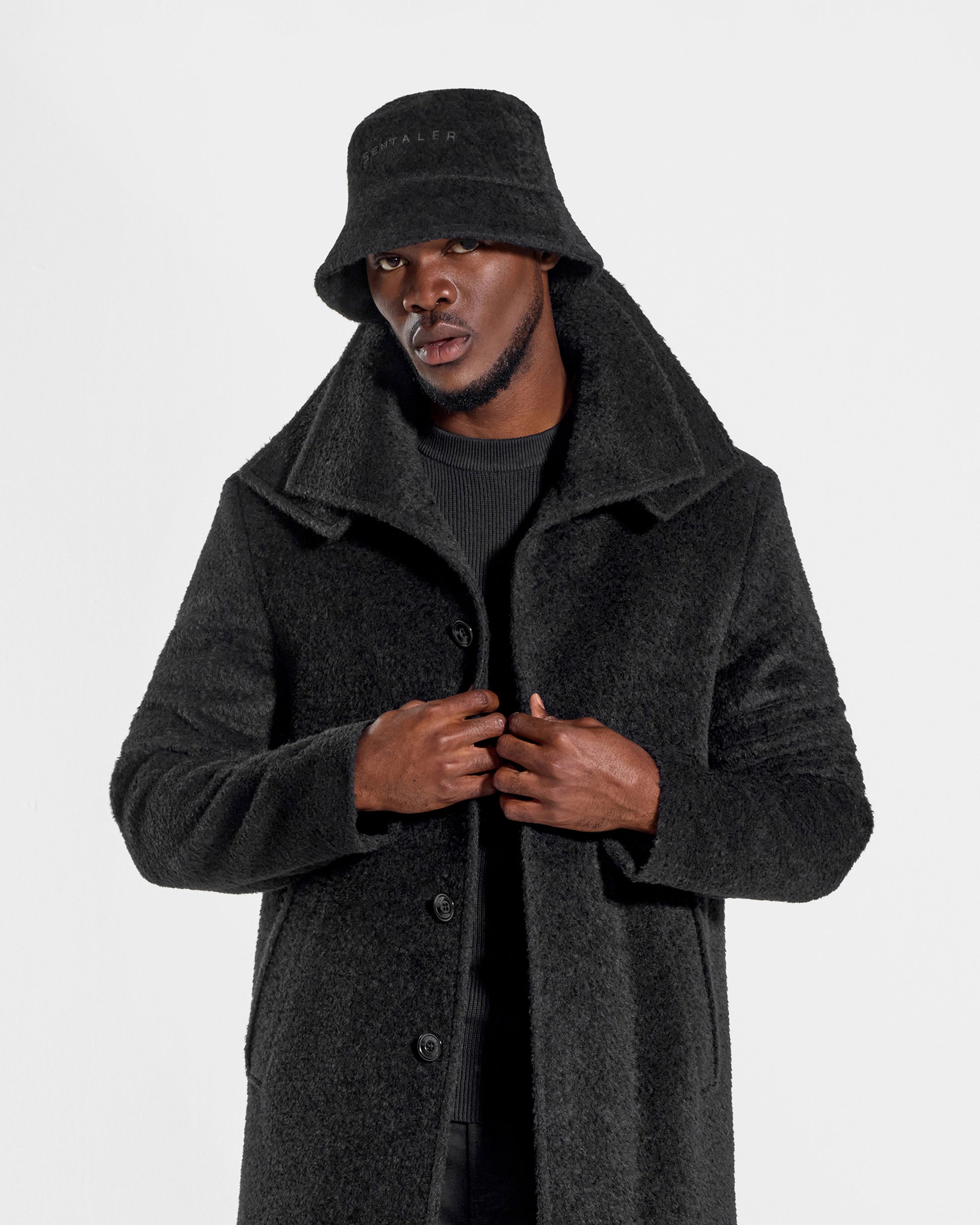 Sentaler Mens Bouclé Alpaca Bucket Black Hat in Bouclé Alpaca. Seen from front close up on male model.