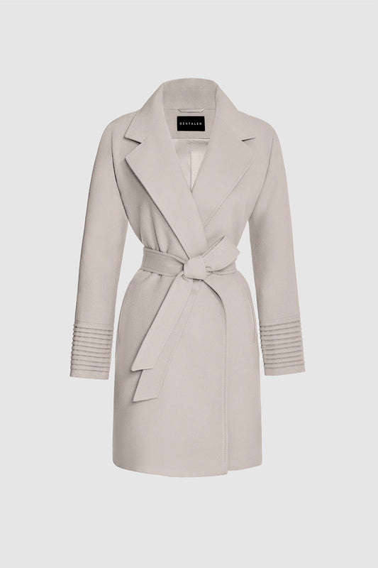Sentaler Mid Length Notched Collar Raglan Sleeve Wrap Coat featured in Baby Alpaca and available in Bleeker Beige. Seen as off figure belted.
