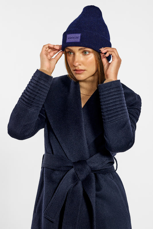 Sentaler Alpaca Beanie and Mid Length Shawl Collar Wrap Coat crafted in Baby Alpaca wool and in Navy. Seen from side above the knees on female model.