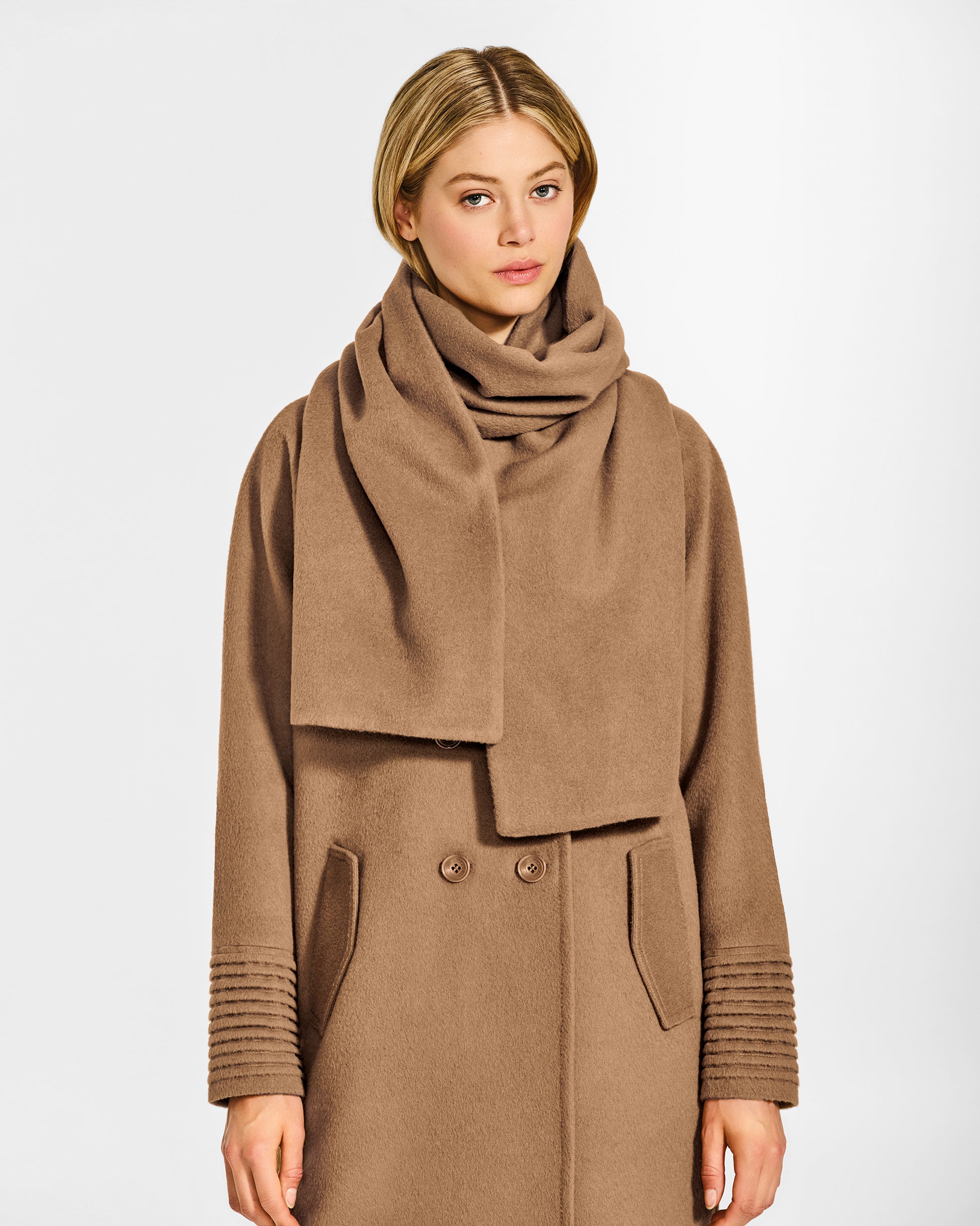 Front view of model wearing Sentaler's Oversized Dark Camel scarf, made of baby alpaca yarn. 