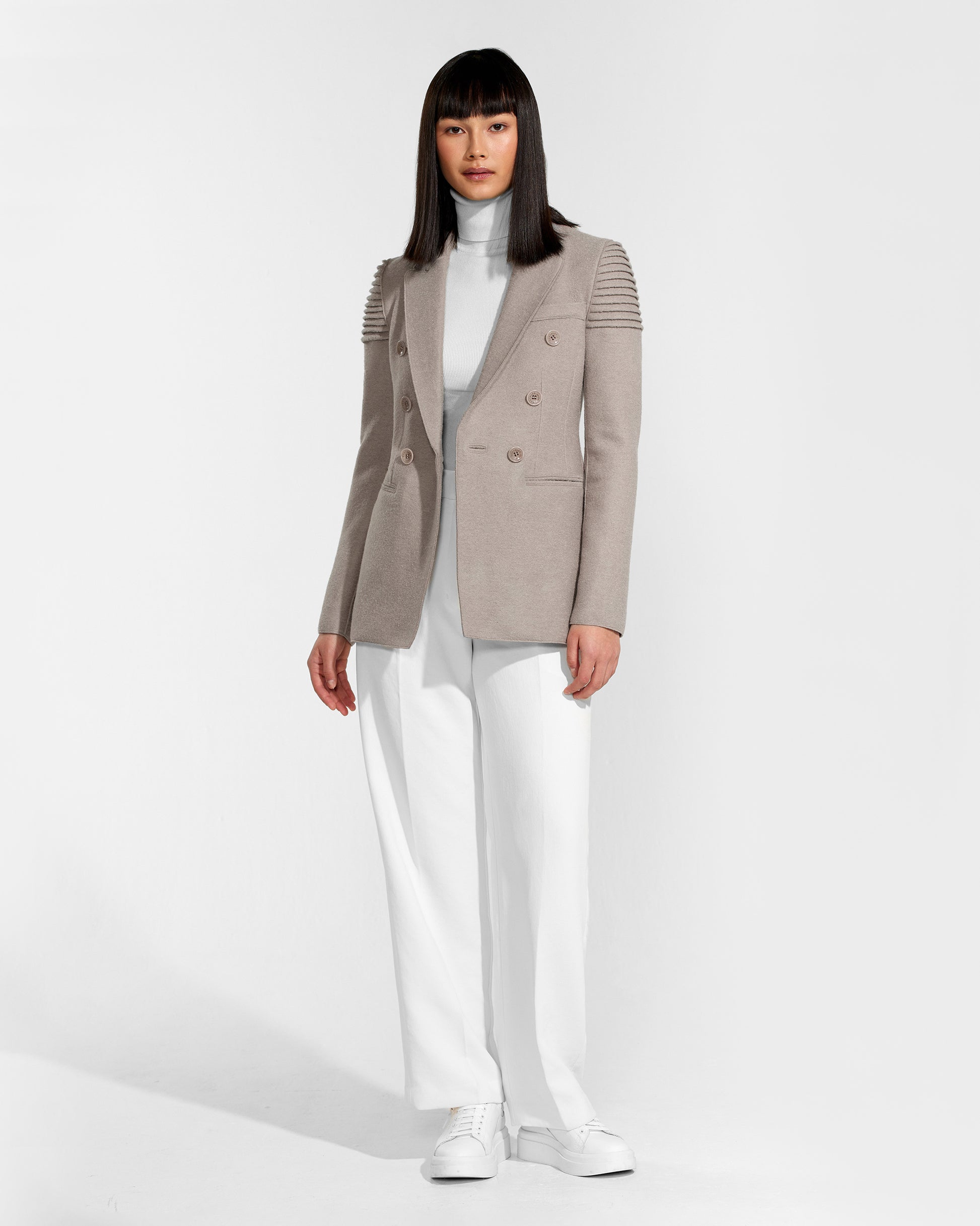 Front view of model wearing a Sentaler double breasted simply taupe blazer made of baby alpaca wool, worn open.