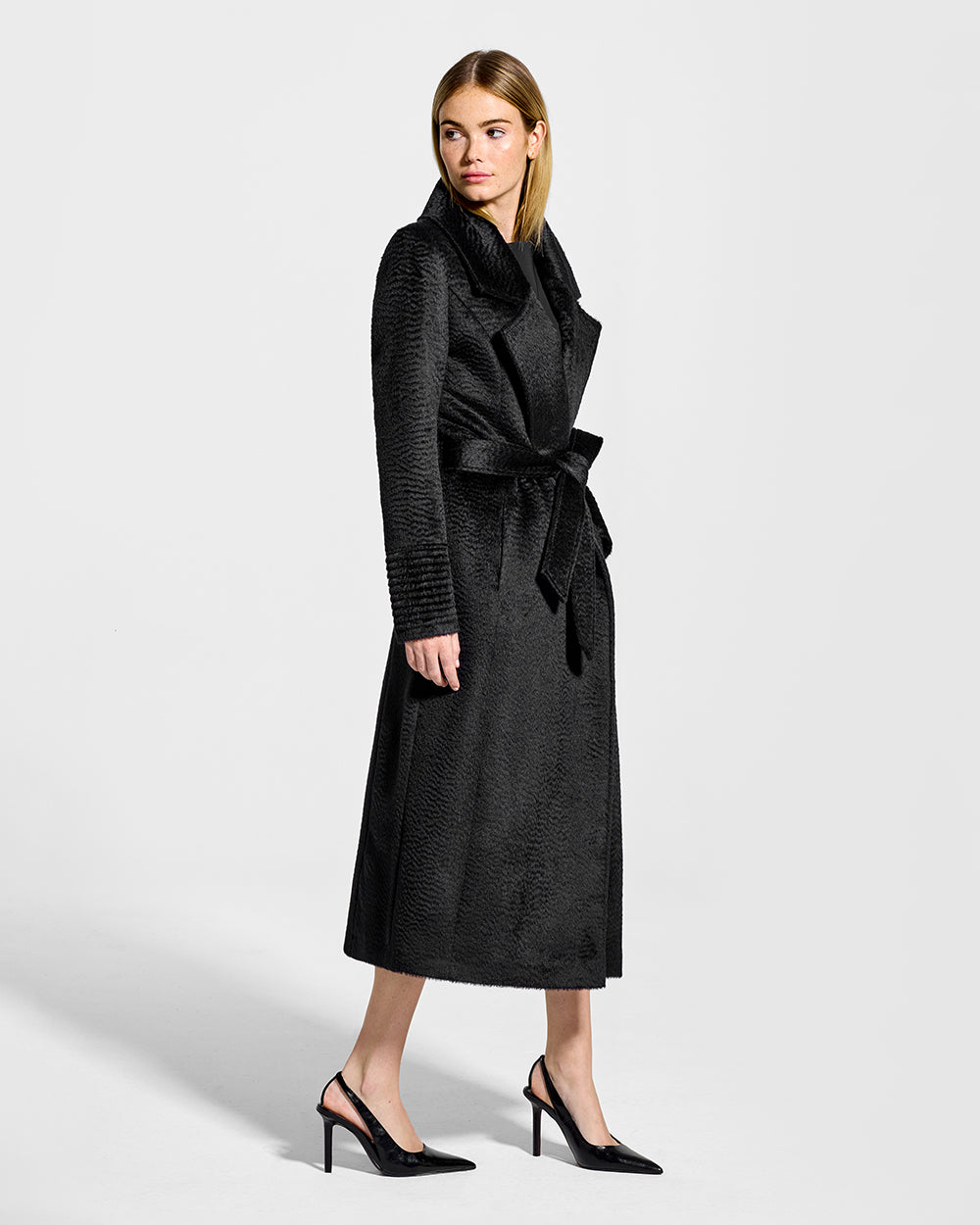 Sentaler Suri Alpaca Long Notched Collar Wrap Black Coat in Suri Alpaca wool. Seen from side belted on female model.