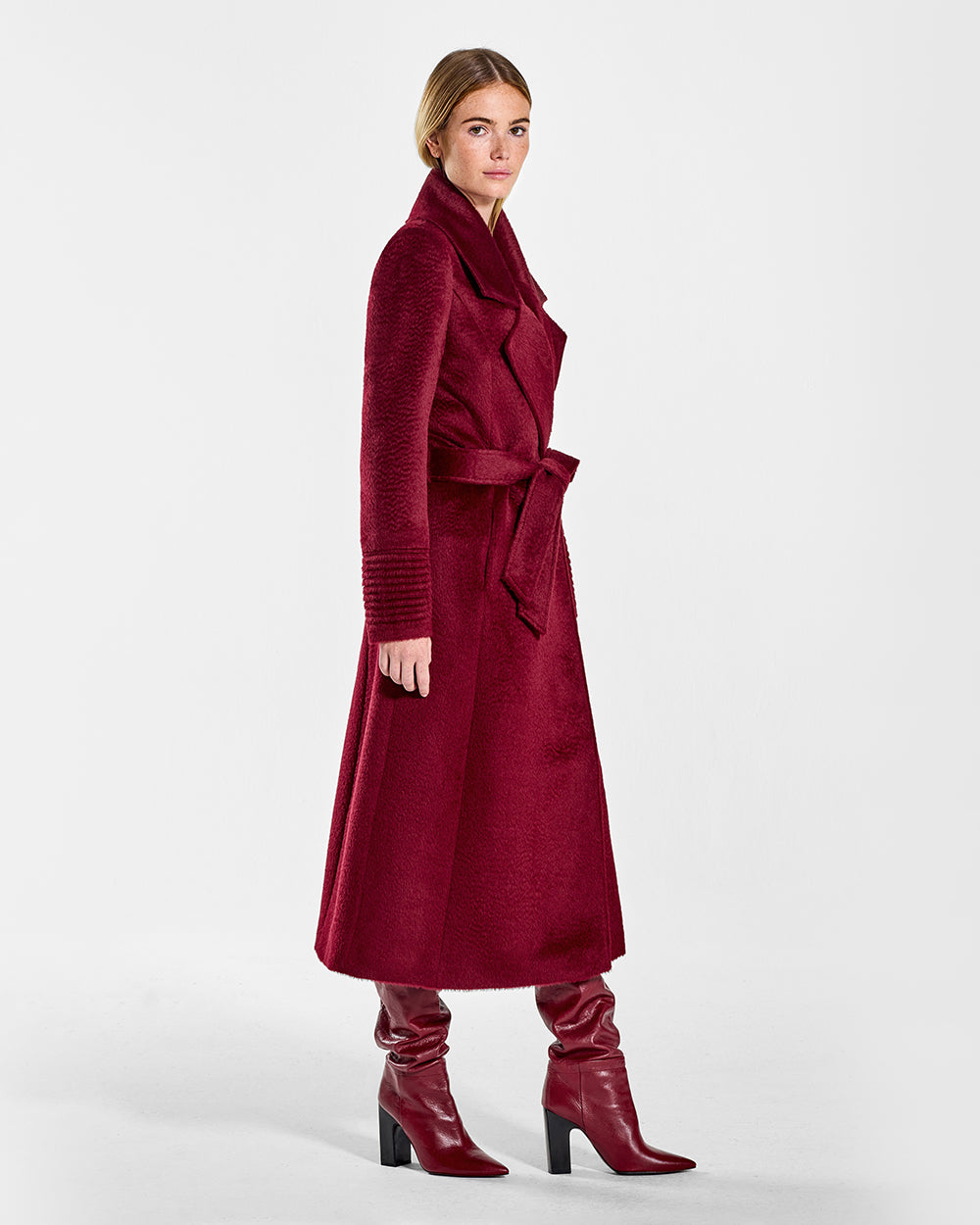 Sentaler Suri Alpaca Long Notched Collar Wrap Bordeaux Coat in Suri Alpaca wool. Seen from side belted on female model.