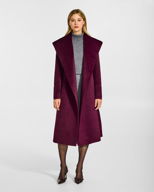 Front view of model wearing a Sentaler long cherry lacquer wrap coat made of suri alpaca wool, with a shawl collar, worn open.