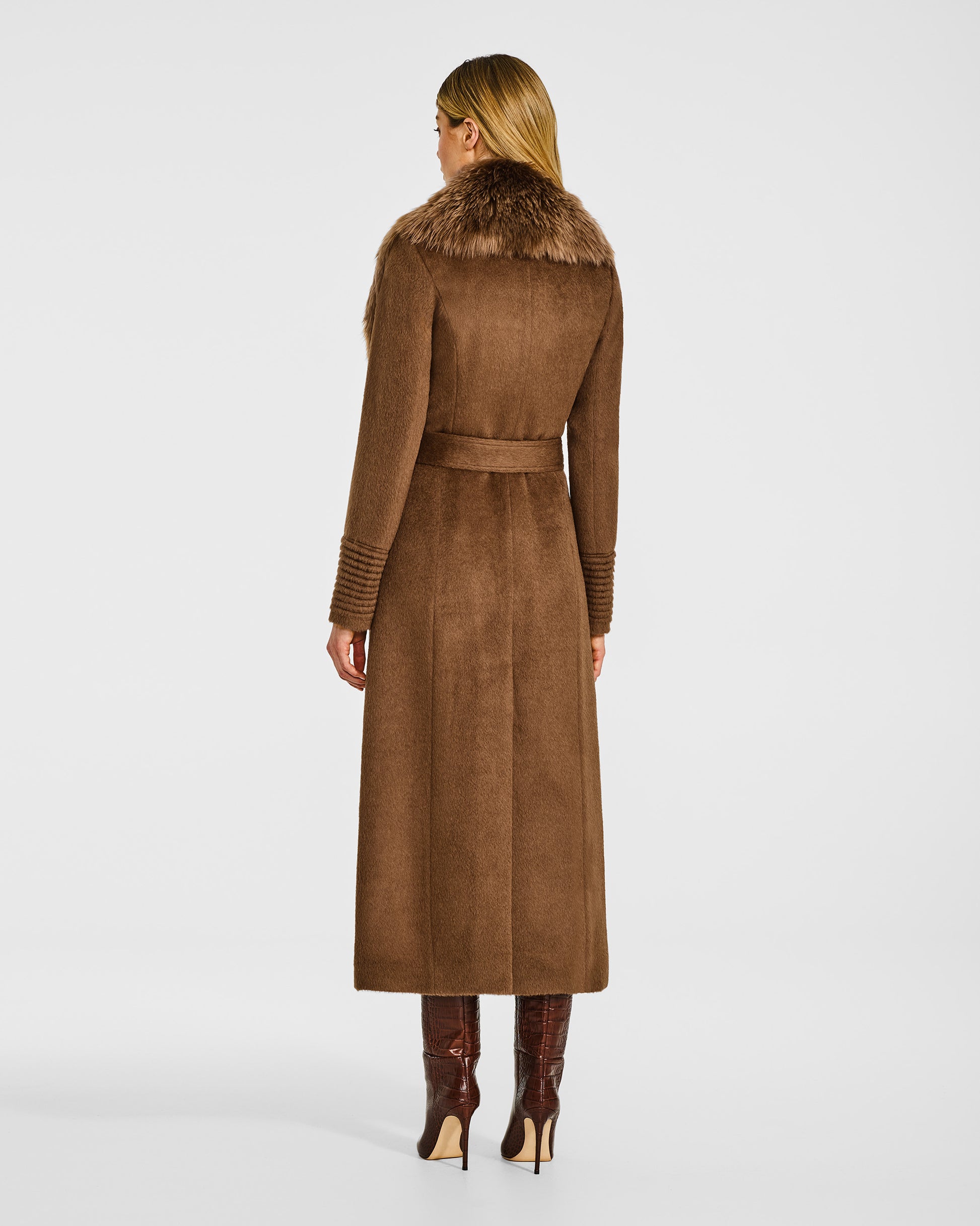 Back view of model in Sentaler maxi caramel coat with alpaca shearling collar in suri alpaca wool, belted.