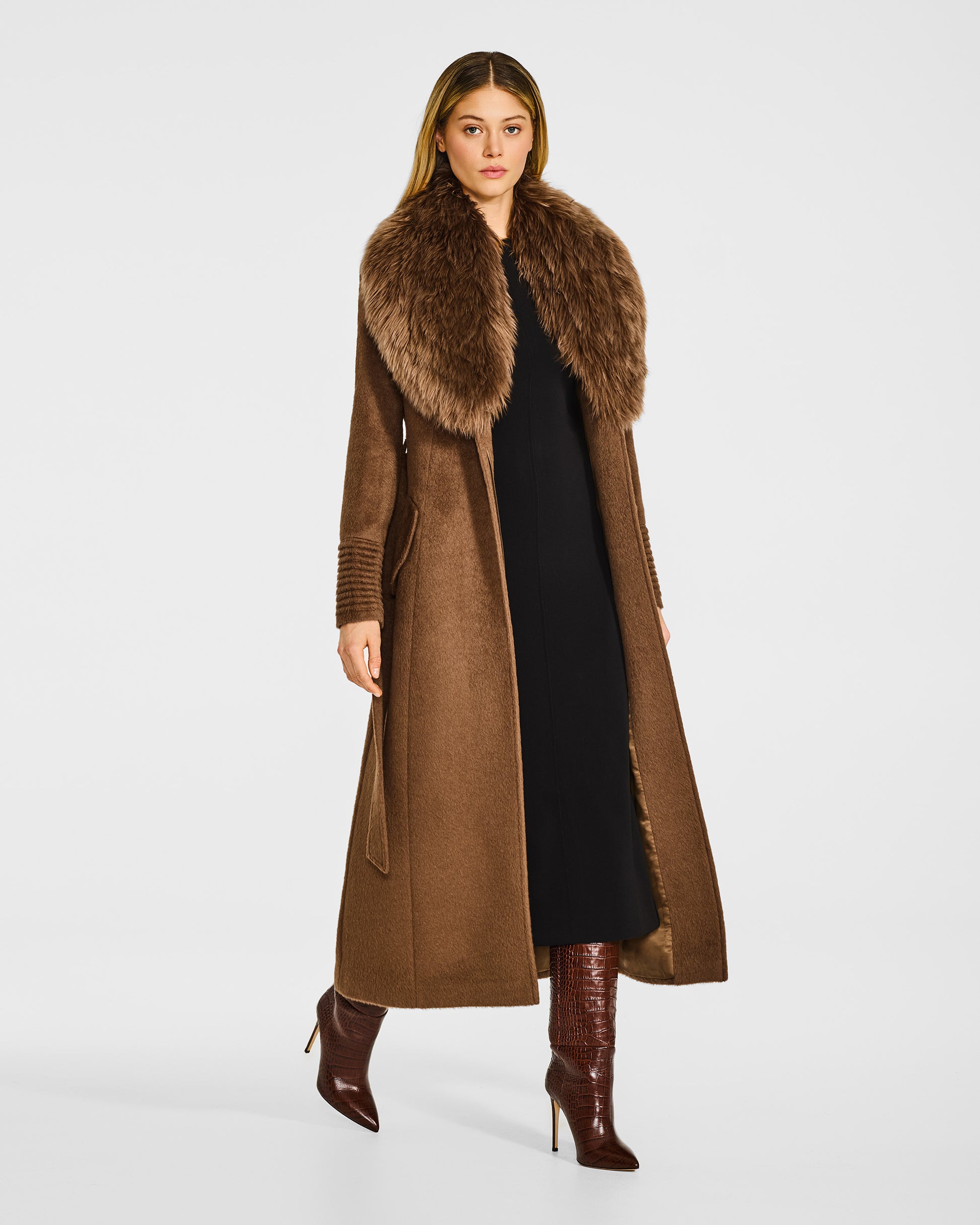 Side view of model in Sentaler maxi caramel coat with alpaca shearling collar in suri alpaca wool, open.
