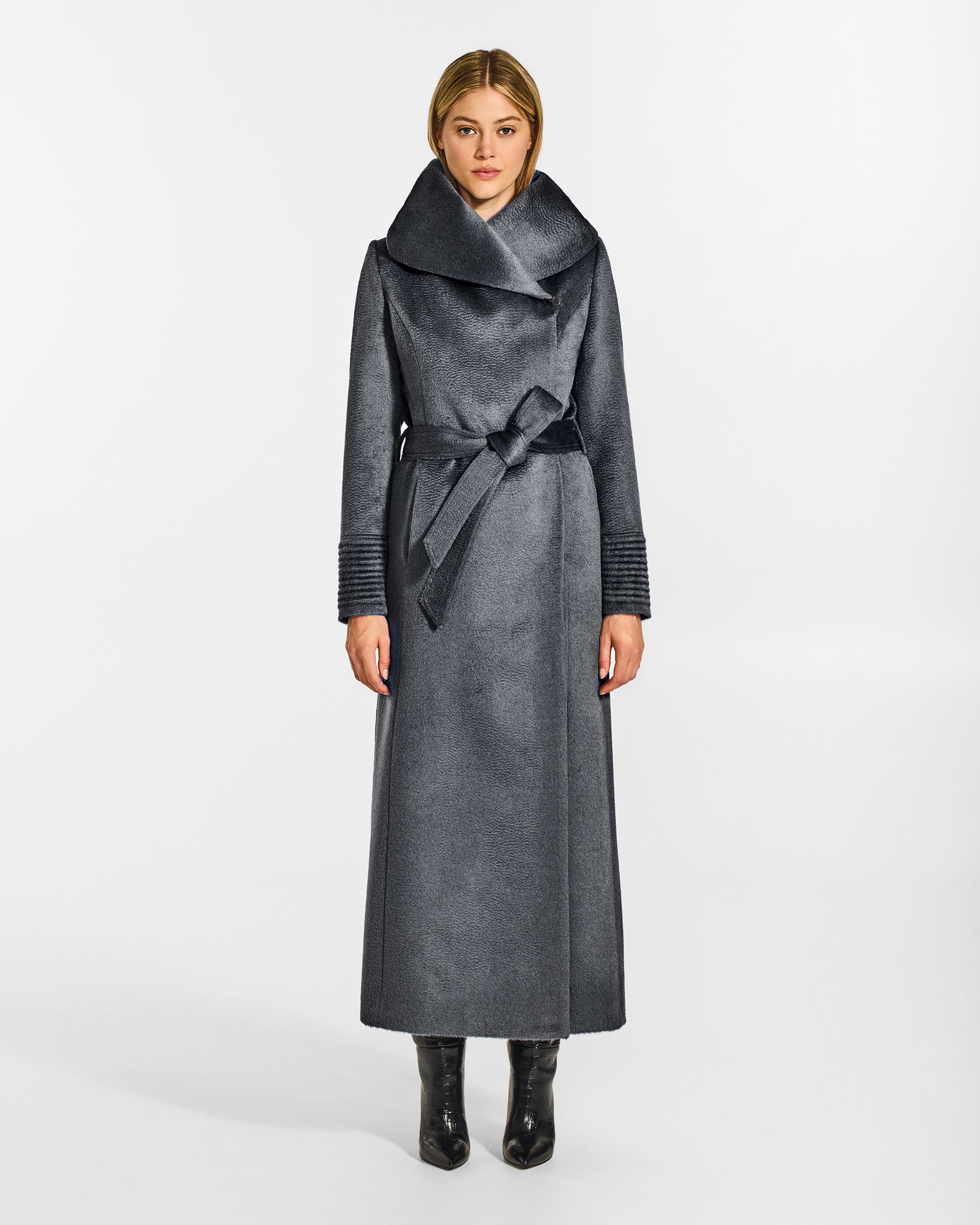 Front view of model wearing a Sentaler maxi graphite coat made of suri alpaca wool, with a hooded collar, worn belted.