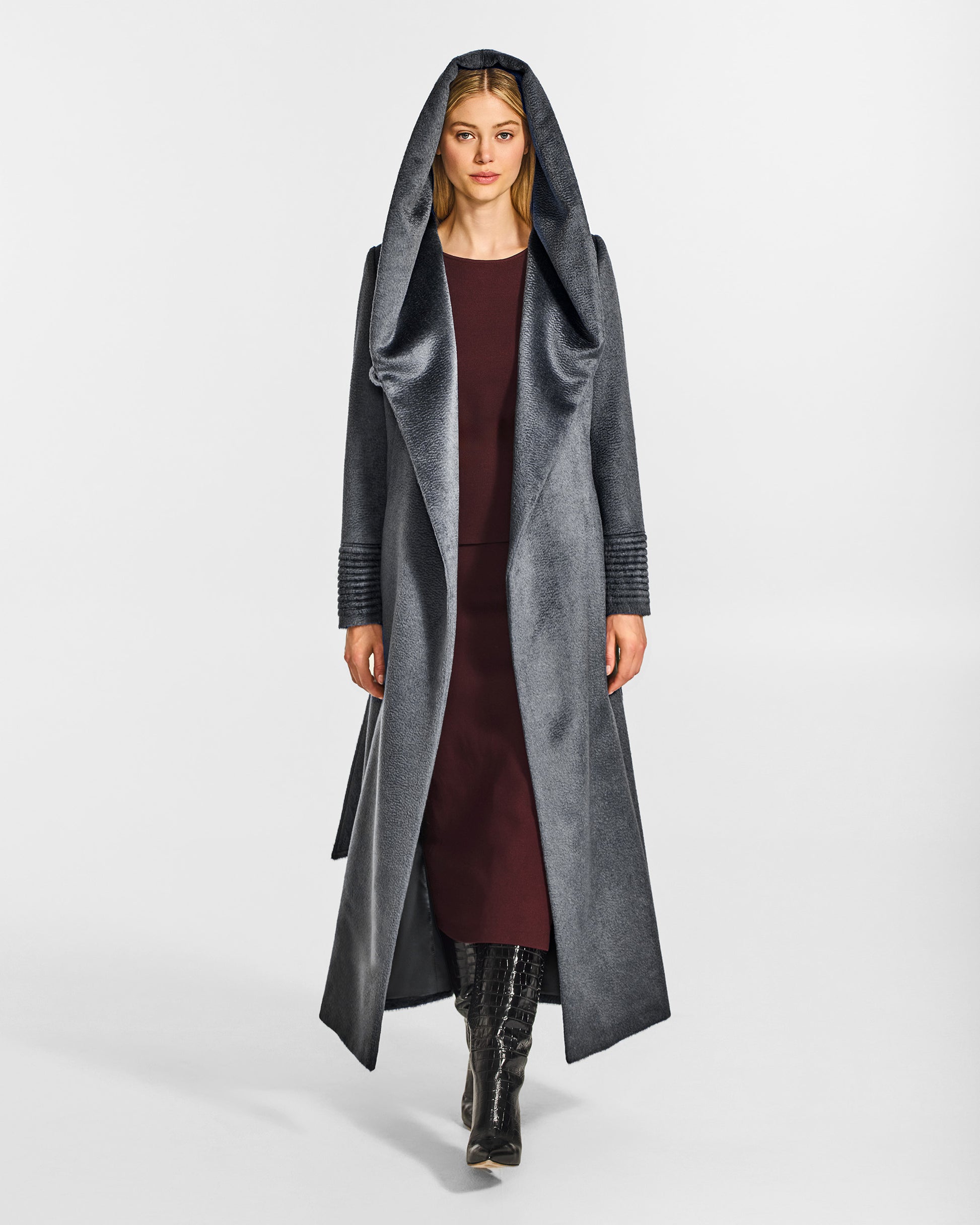 Front view of model wearing a Sentaler maxi graphite coat made of suri alpaca wool, with a hooded collar, worn open.