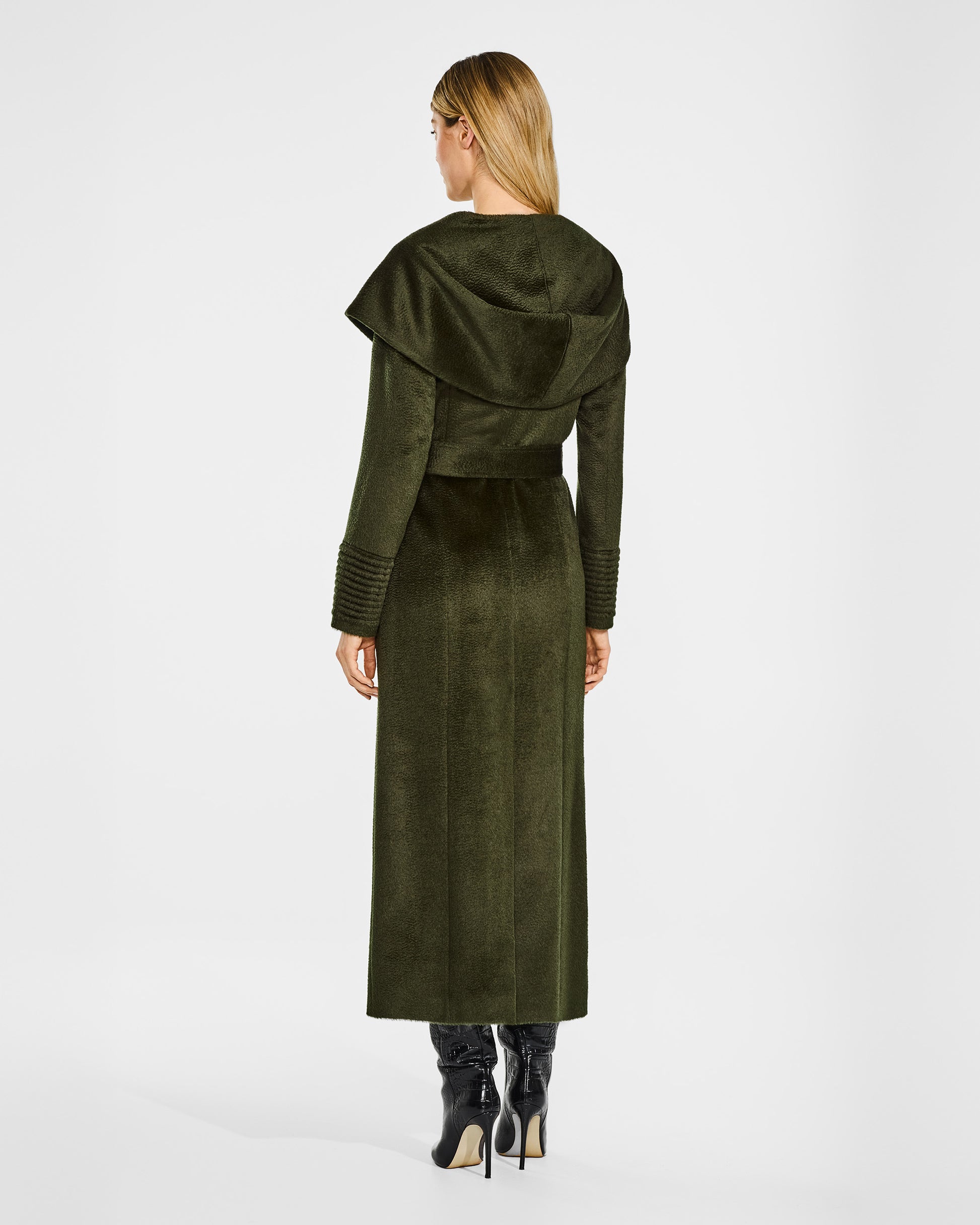 Back view of model wearing a Sentaler maxi olive green coat made of suri alpaca wool, with a hooded collar, worn belted with shawl collar.