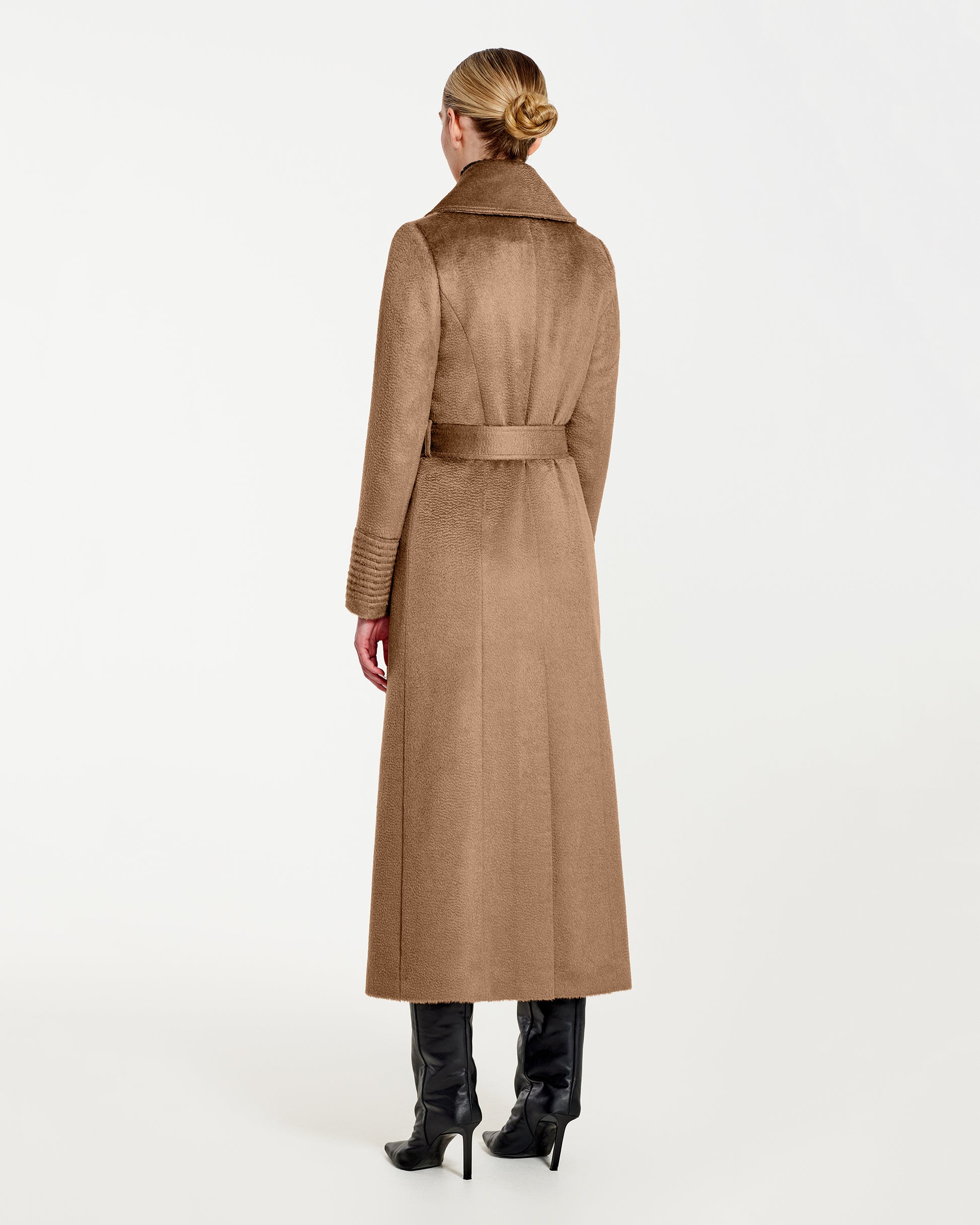Back view of model wearing a Sentaler dark camel maxi coat made of suri alpaca wool, with a notched collar, worn belted.