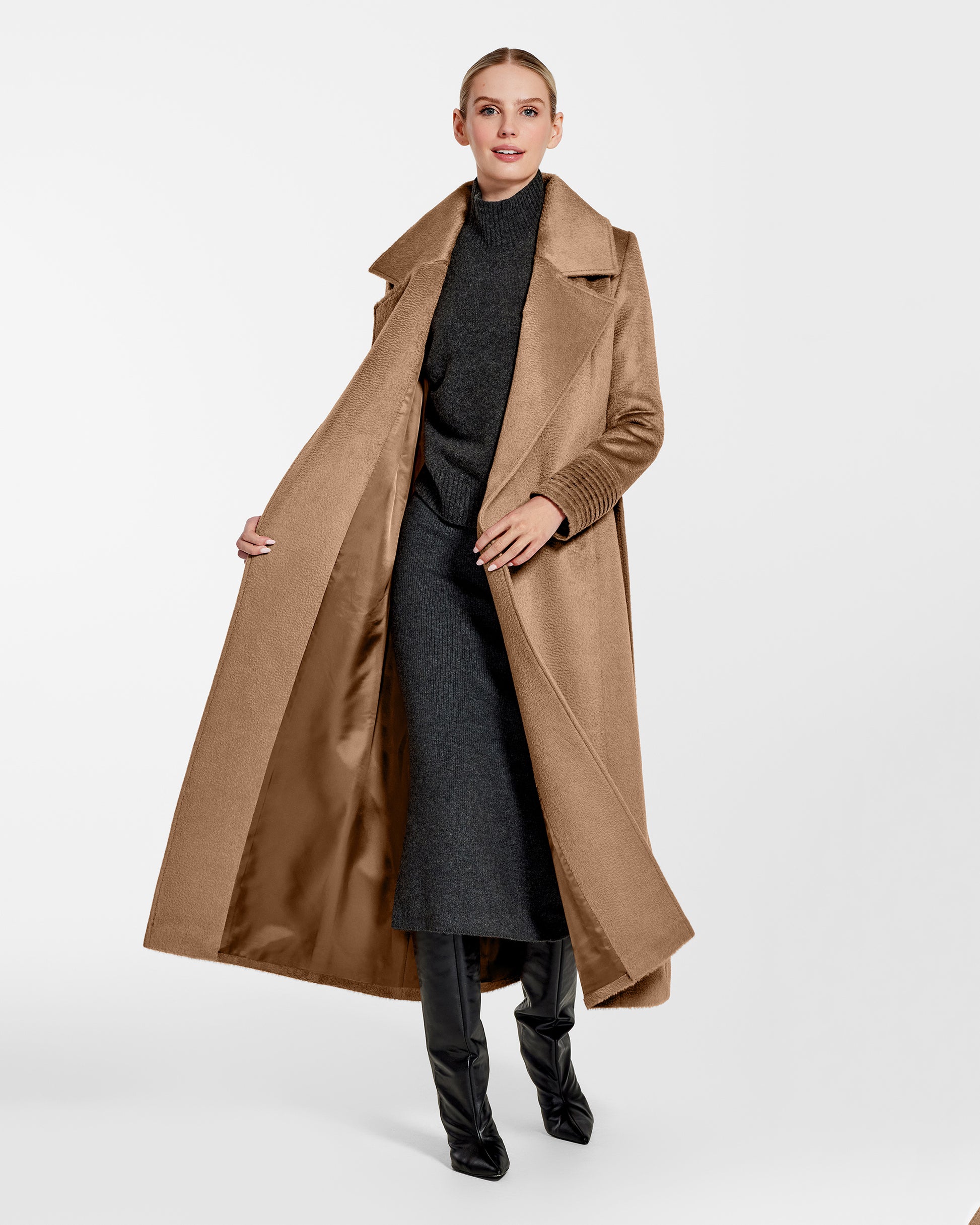Front view of model wearing a Sentaler dark camel maxi coat made of suri alpaca wool, with a notched collar, worn open.