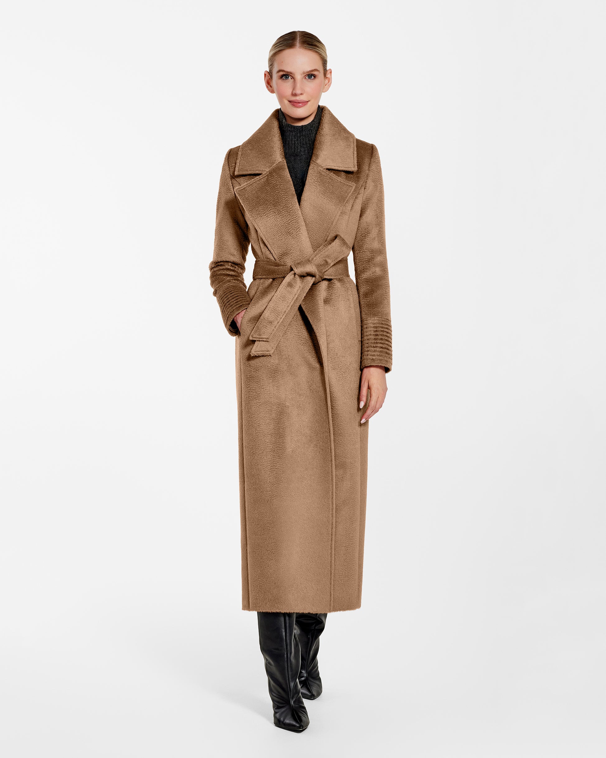 Front view of model wearing a Sentaler dark camel maxi coat made of suri alpaca wool, with a notched collar, worn belted.