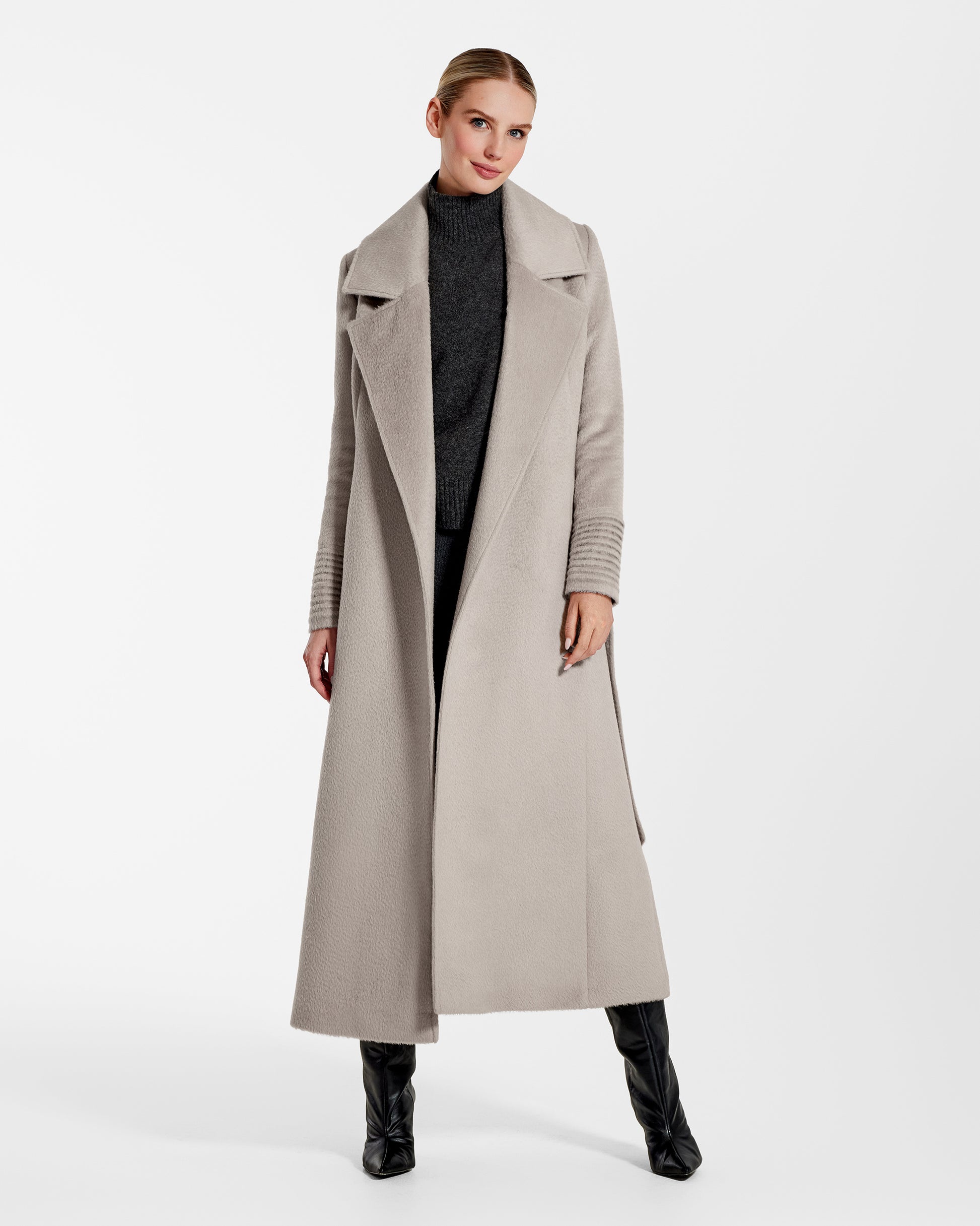 Front view of model wearing a Sentaler sand maxi coat made of suri alpaca wool, with a notched collar, worn open.