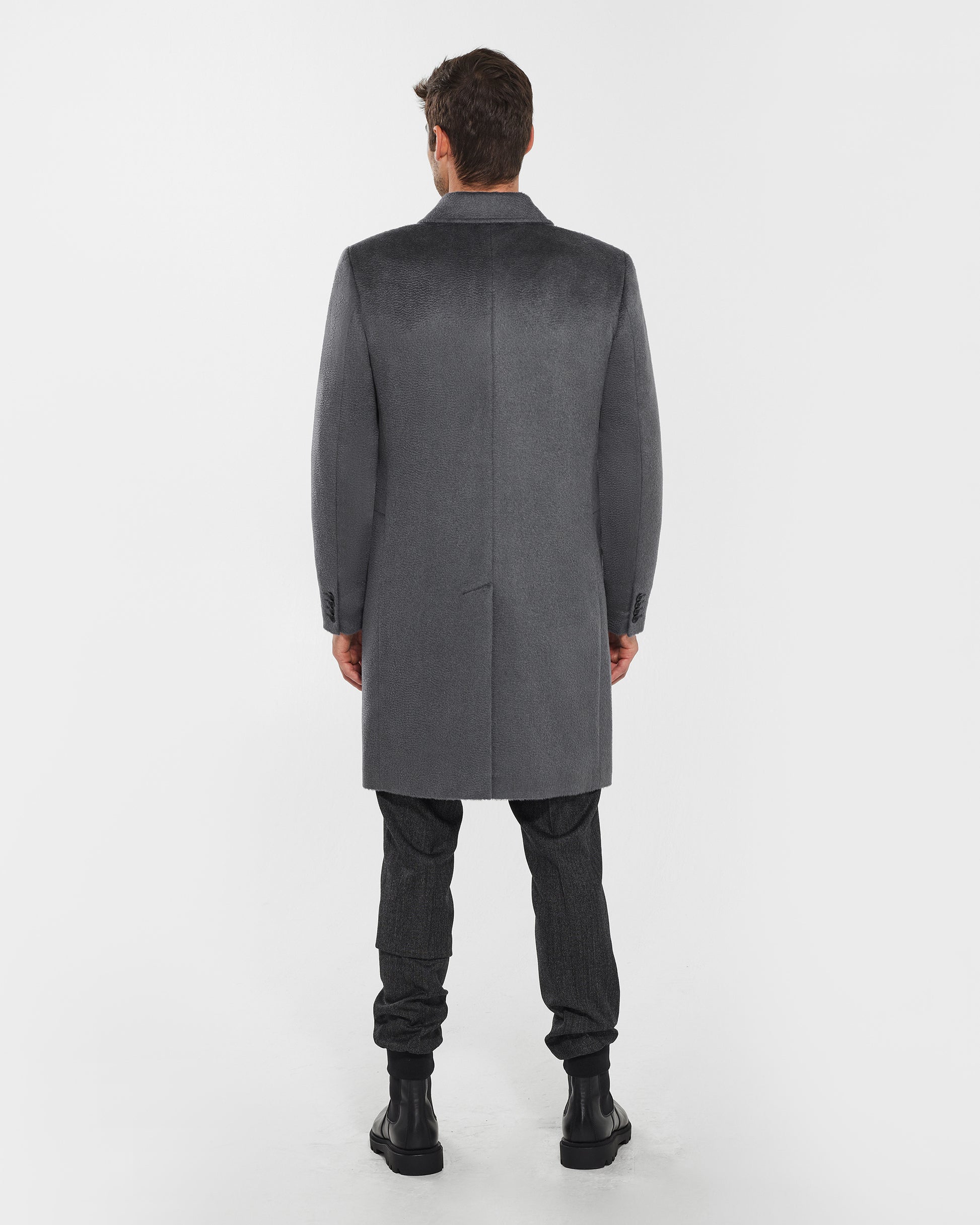 Sentaler Notched Lapel Bold Graphite Grey Overcoat in Suri Alpaca wool. Seen from back on male model, worn buttoned.