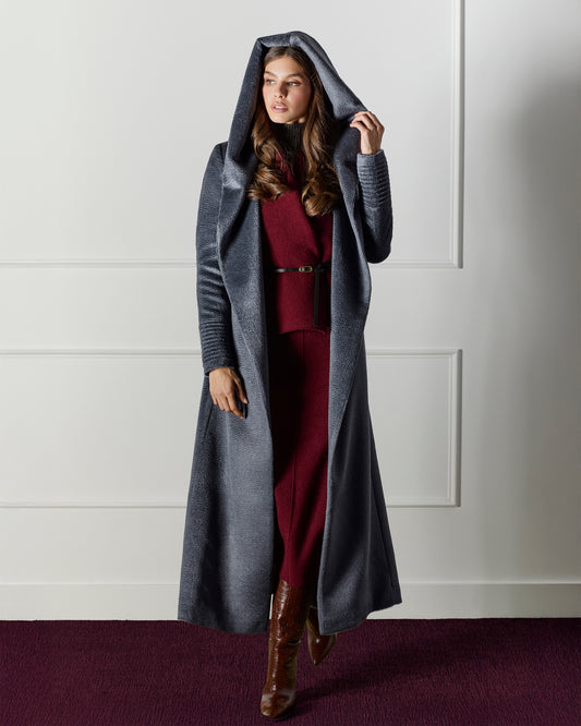 Front view of model wearing a Sentaler maxi graphite coat made of suri alpaca wool, with a hooded collar, worn open.