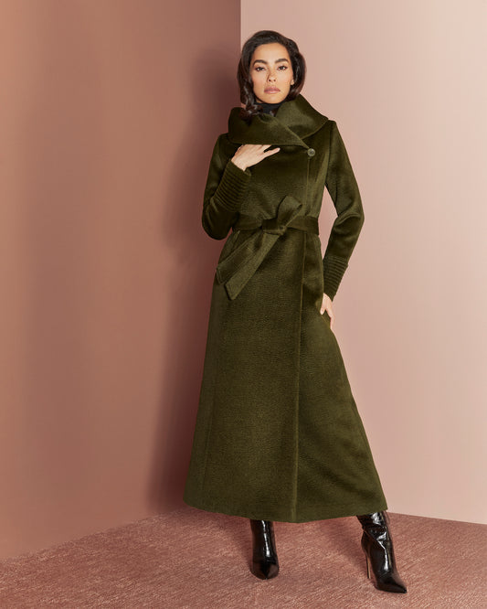 Front view of model wearing a Sentaler maxi olive coat made of suri alpaca wool, with a hooded collar, worn belted.