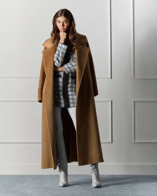 Front view of model wearing a Sentaler dark camel maxi coat made of suri alpaca wool, with a notched collar, worn open.