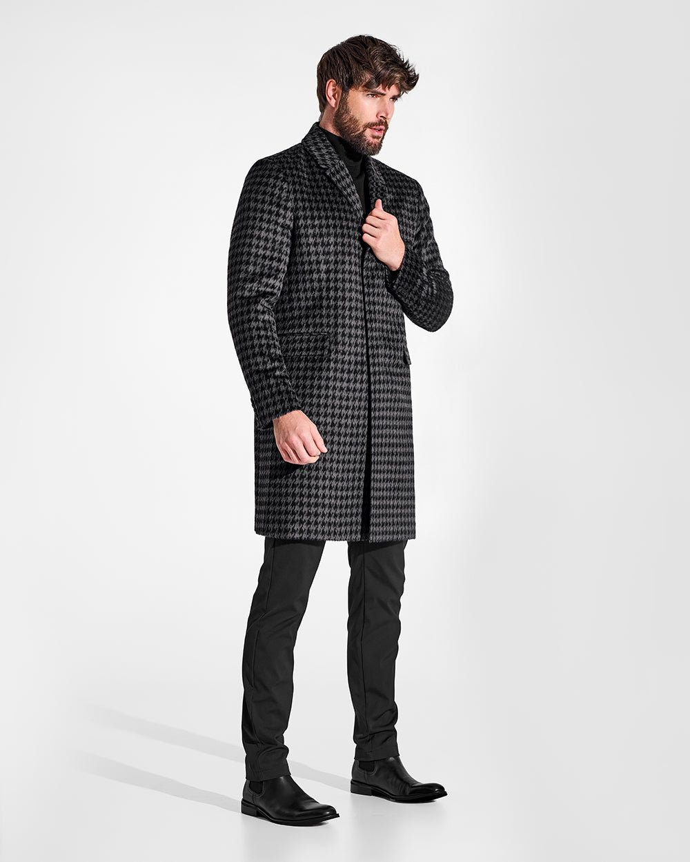 Sentaler Suri Alpaca Notched Lapel Black & Graphite Houndstooth Overcoat in Technical Suri Alpaca wool. Seen from side on male model.