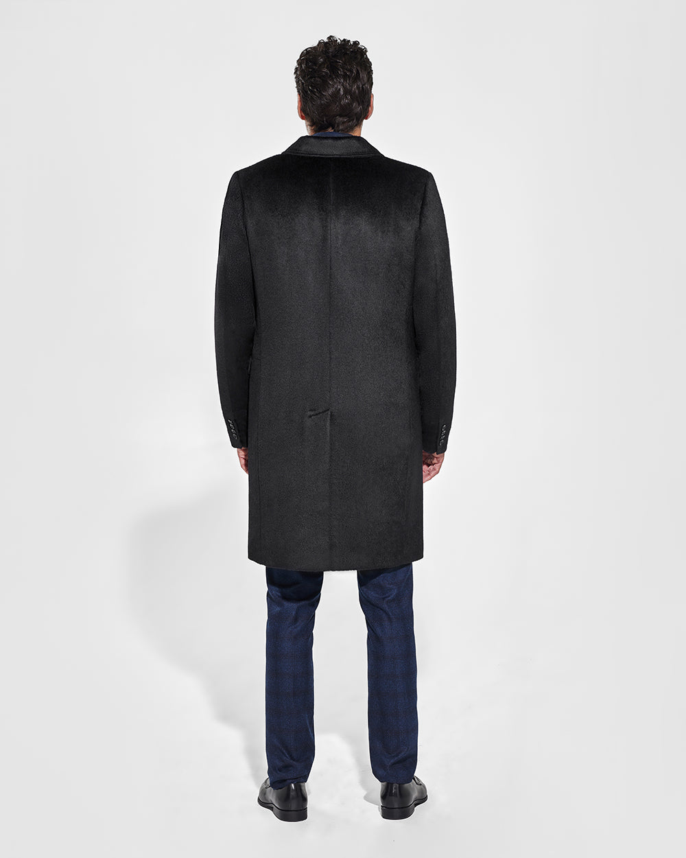 Sentaler Suri Alpaca Notched Lapel Black Overcoat in Technical Suri Alpaca wool. Seen from back on male model.