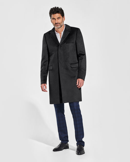 Sentaler Notched Lapel Black Overcoat in Suri Alpaca wool. Seen from front on male model, worn buttoned.