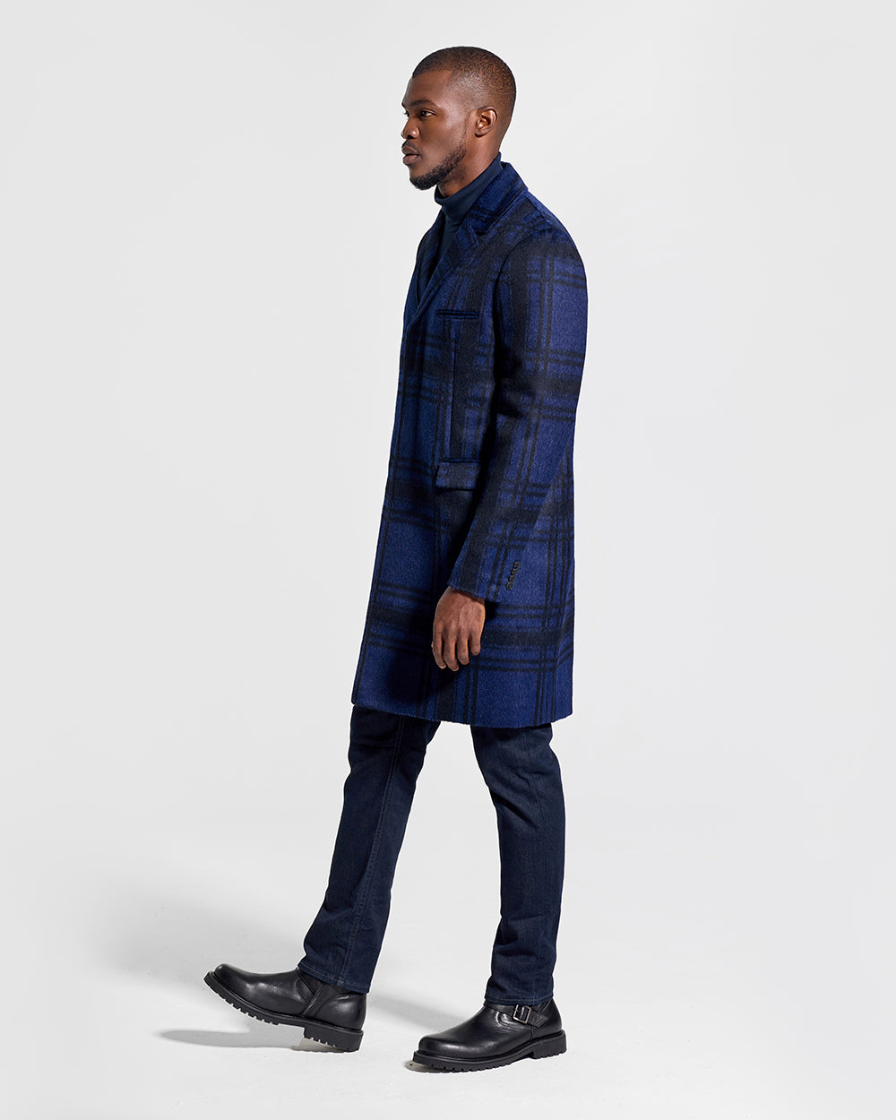 Sentaler Suri Alpaca Notched Lapel Navy Plaid Overcoat in Technical Suri Alpaca wool. Seen from side on male model.