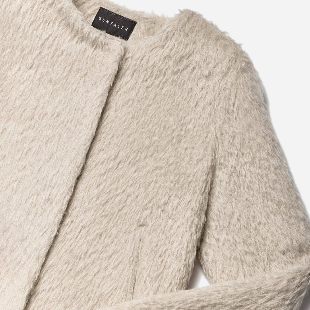 Close up of textured suri oat coat.