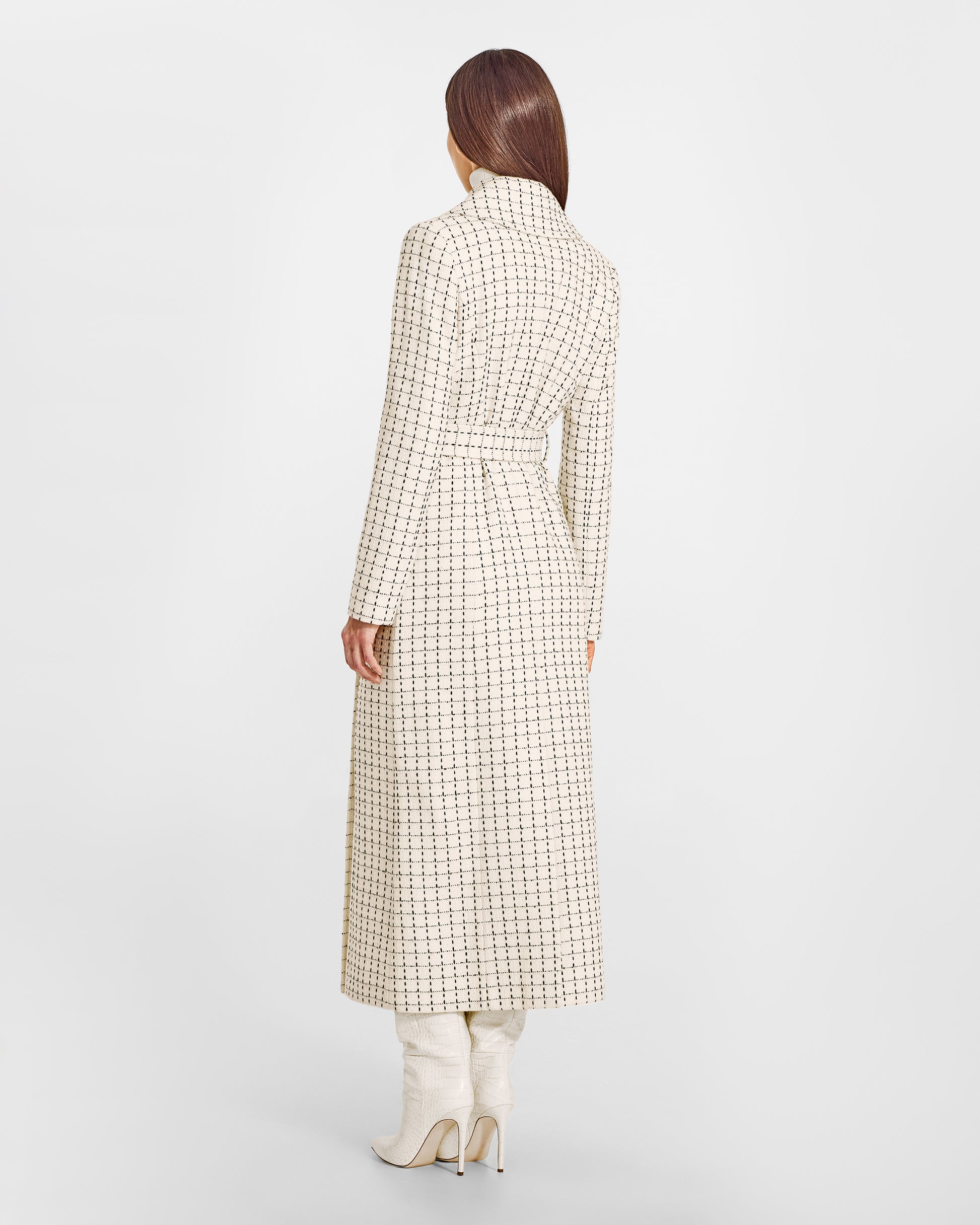 Back view of model wearing a Sentaler ivory check maxi coat made of suri alpaca wool, with a notched collar, worn belted.