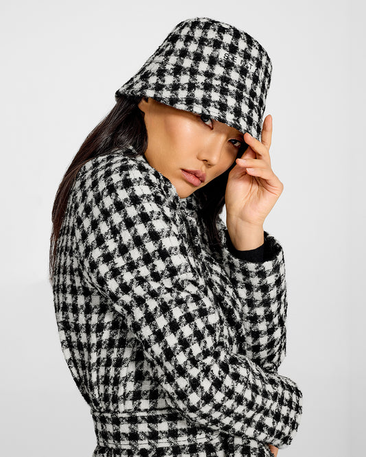 Sentaler Tweed Black and White Houndstooth Bucket Hat in Tweed Suri Alpaca wool. Seen from side close up on female model.