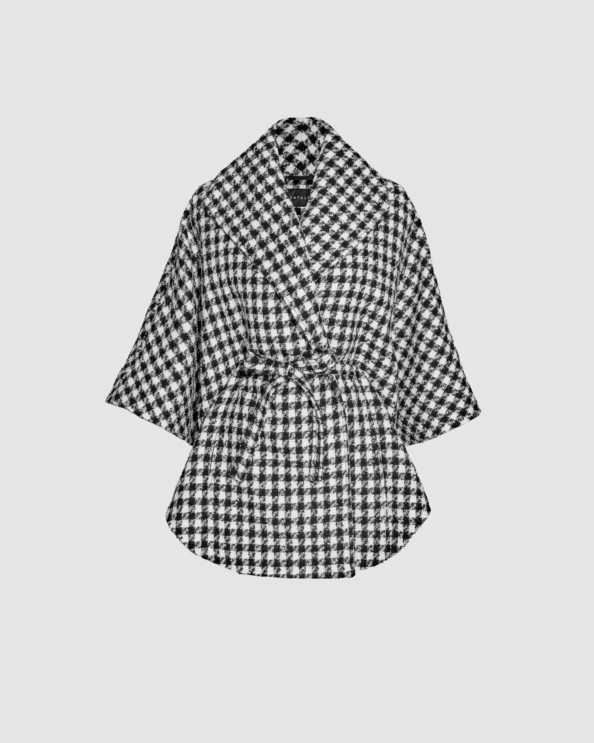 Sentaler black and white houndstoth cape made of tweed suri alpaca wool, worn belted.