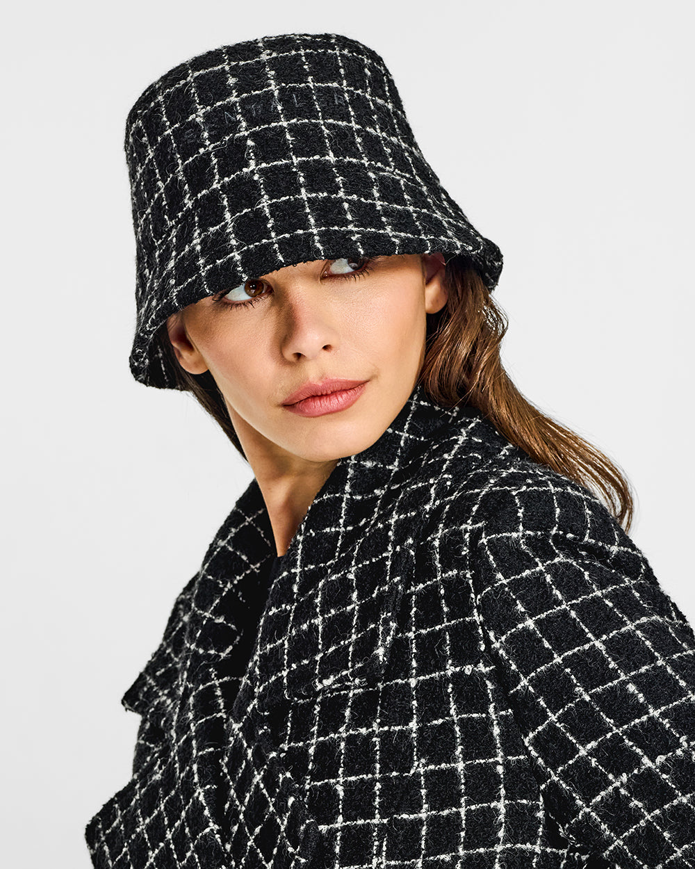 Sentaler Tweed Black Check Bucket Hat in Tweed Suri Alpaca wool. Seen from front close up on female model.