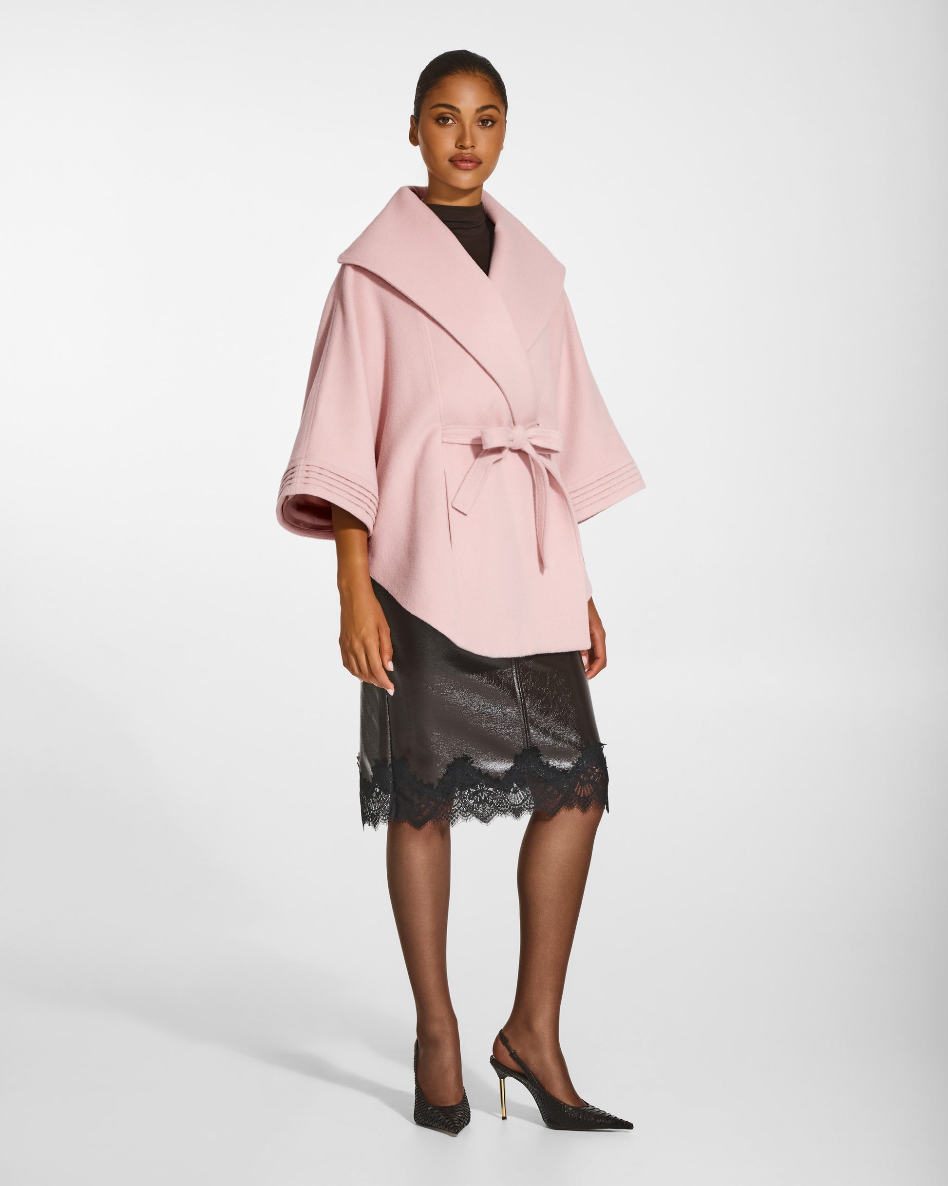 SENTALER Cape with Shawl Collar and Belt in Pink Frost, Baby Alpaca. Worn by a female model, side view, belted.