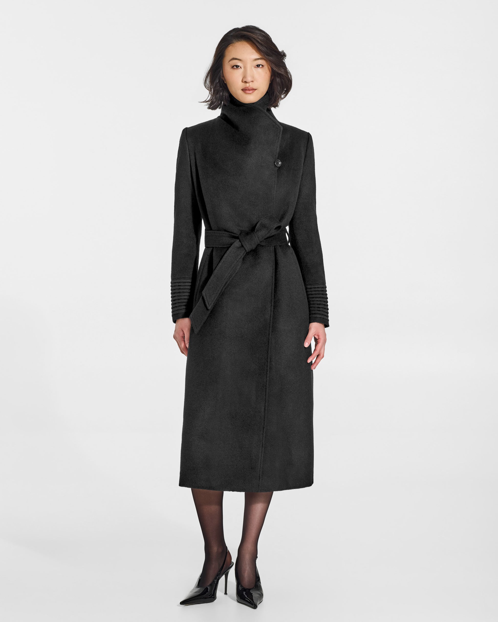 SENTALER Long Funnel Collar Wrap Coat in Black, Baby Alpaca. Worn by a female model, front view, belted.