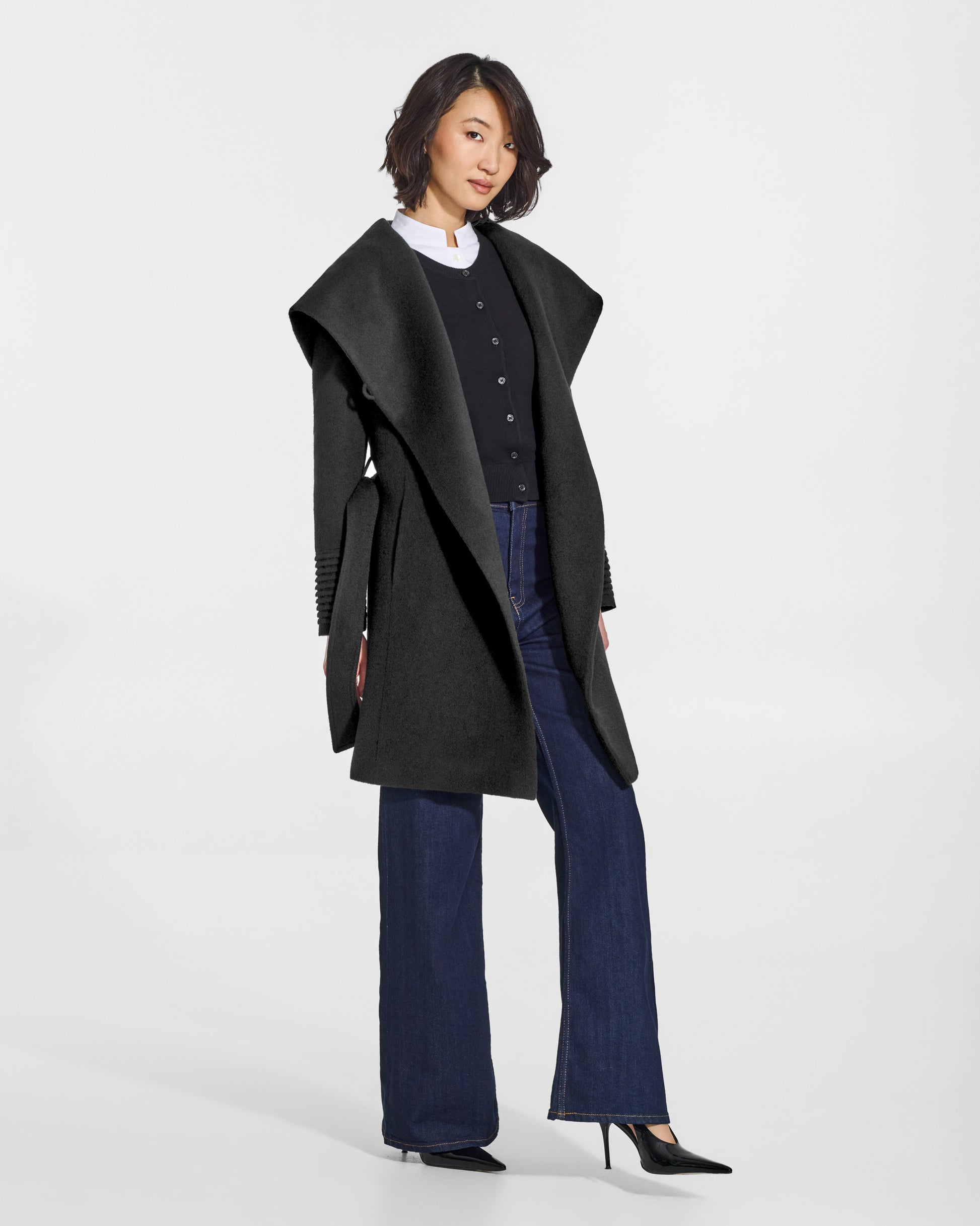 SENTALER Mid Length Hooded Wrap Coat in Black, Baby Alpaca. Worn by a female model, side view, open.
