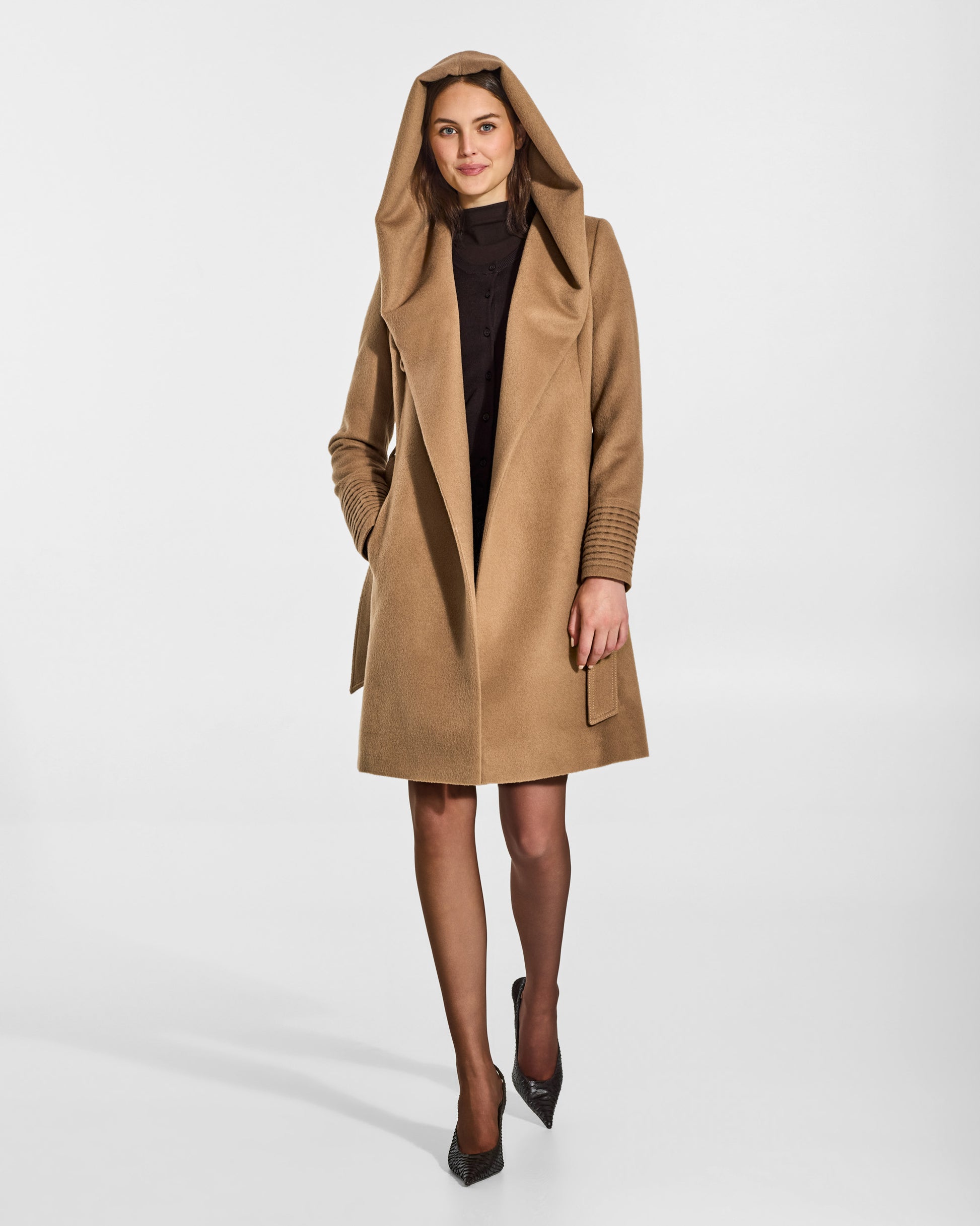 SENTALER Mid Length Hooded Wrap Coat in Dark Camel, Baby Alpaca. Worn by a female model, front view, open with hood.